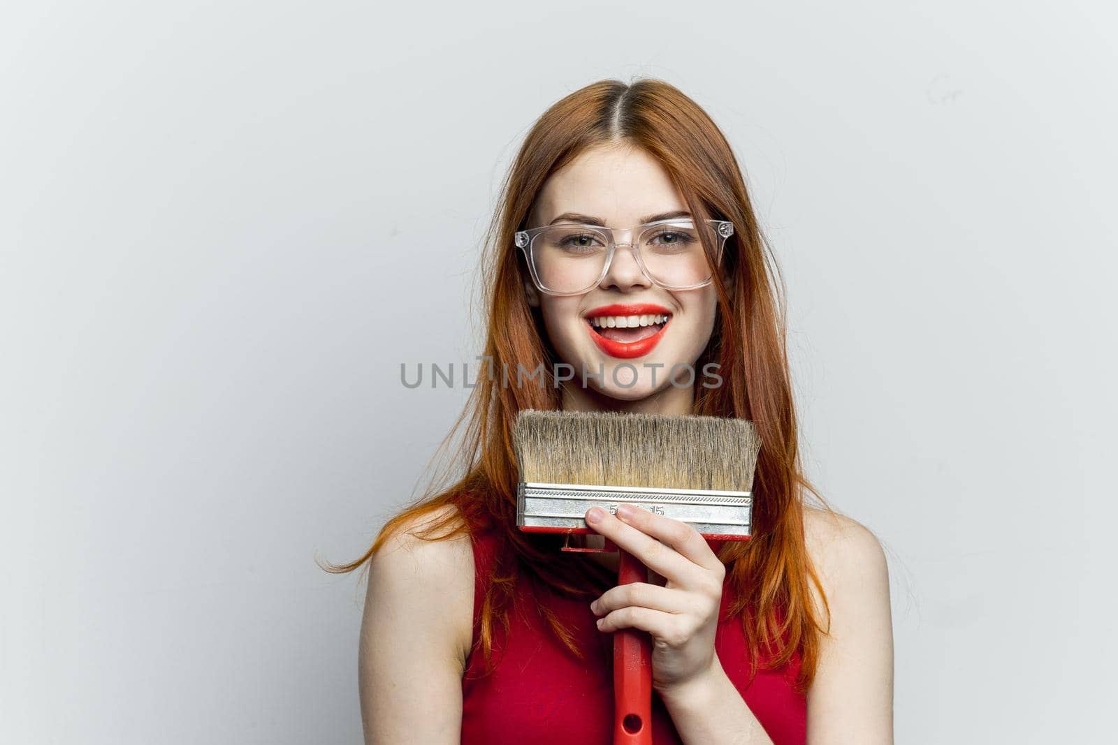 cheerful woman with paint brush housework interior renovation. High quality photo