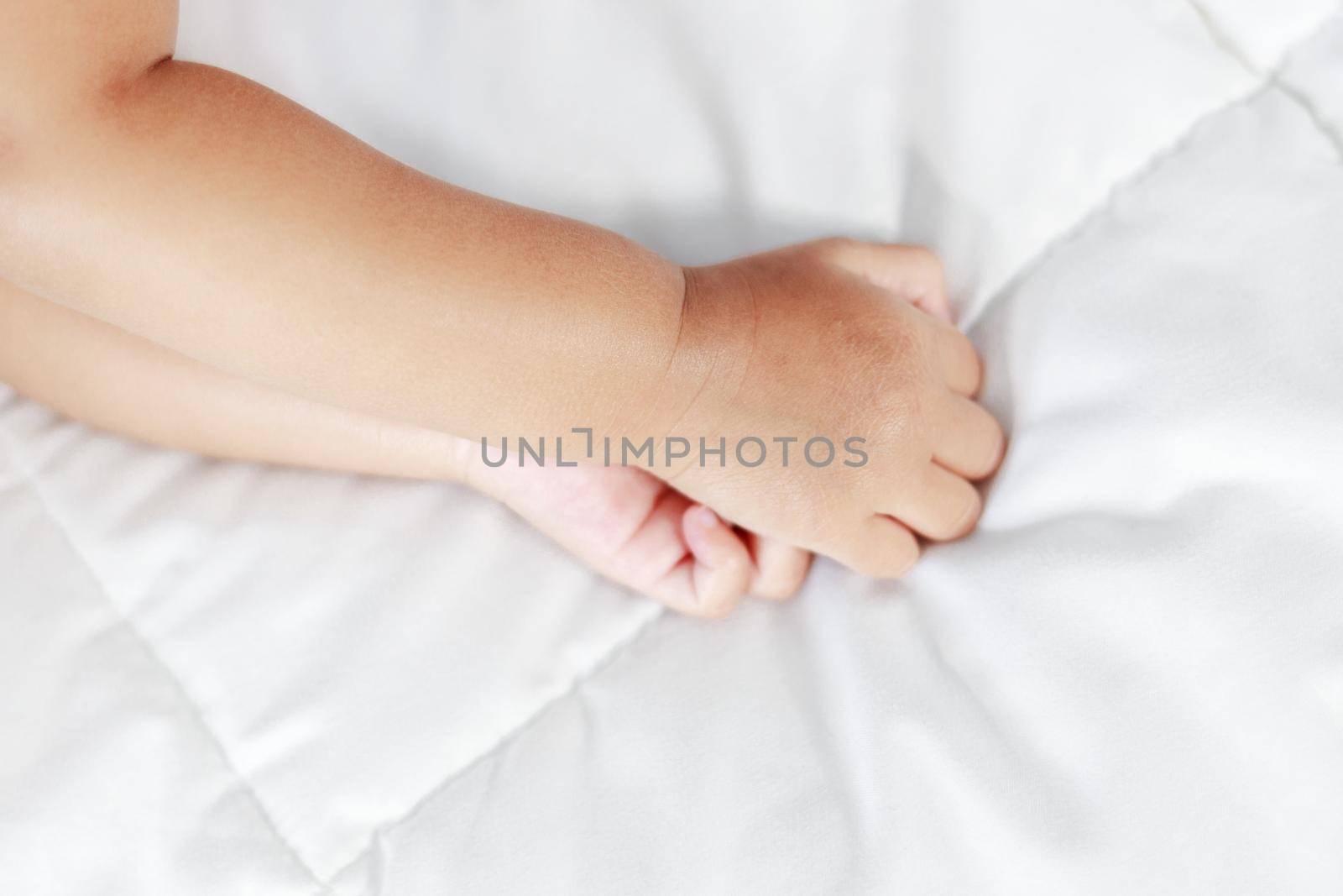 little baby hand on a bed 