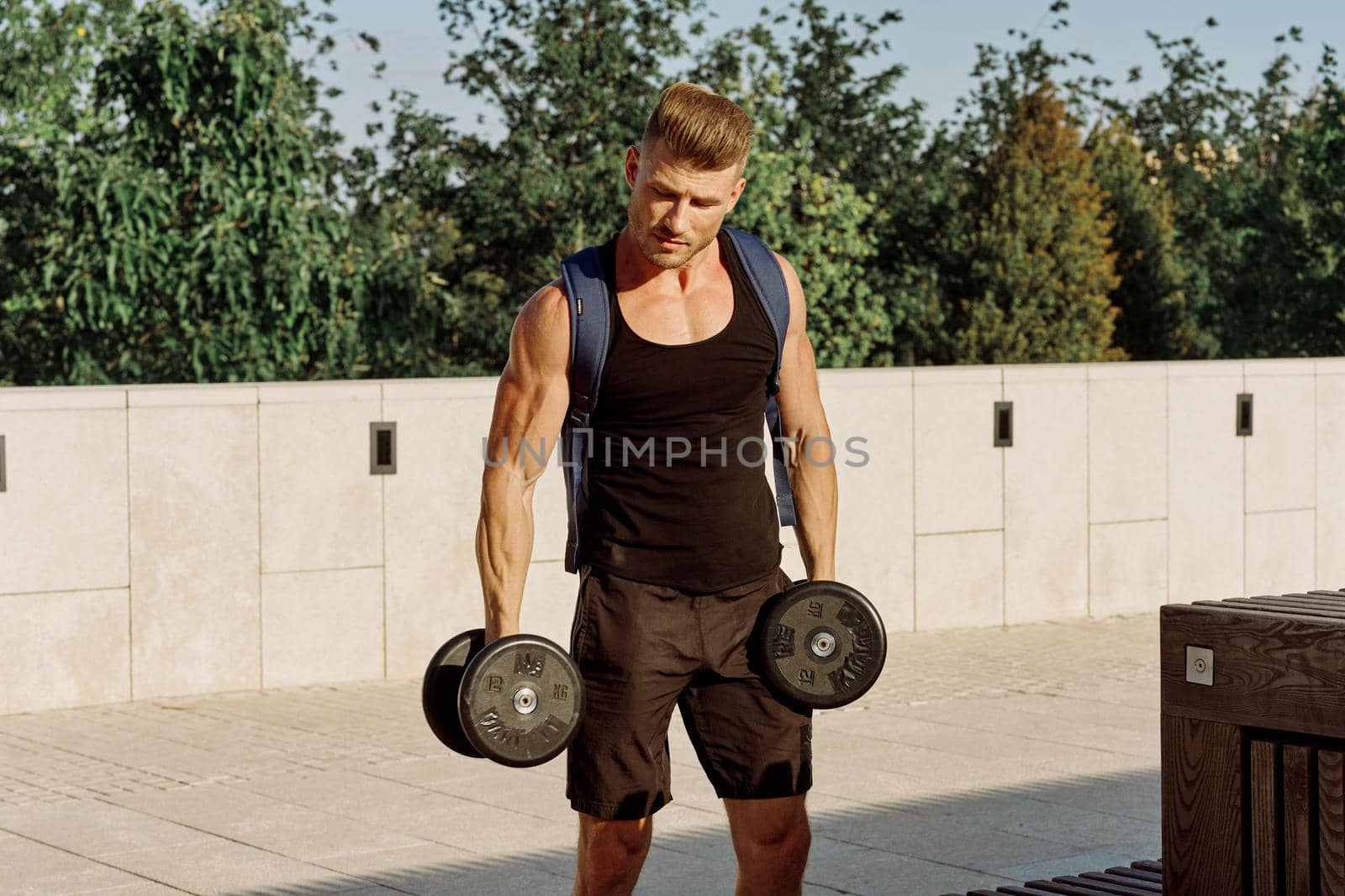 athletic man with dumbbells with pumped up body workout by Vichizh