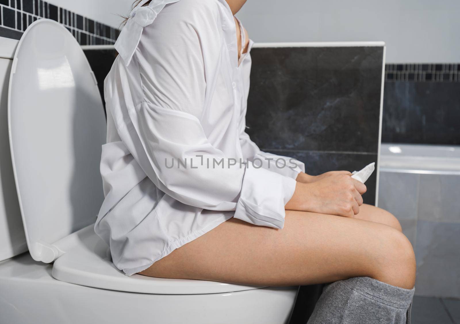 woman sitting on the toilet