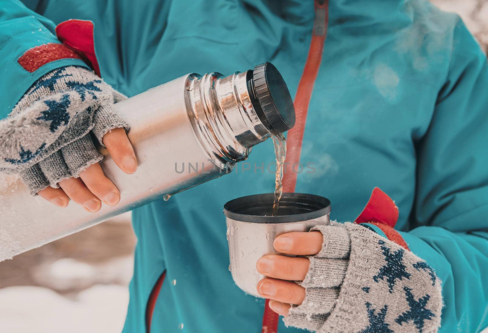 Tourist pouring tea from thermos by alexAleksei