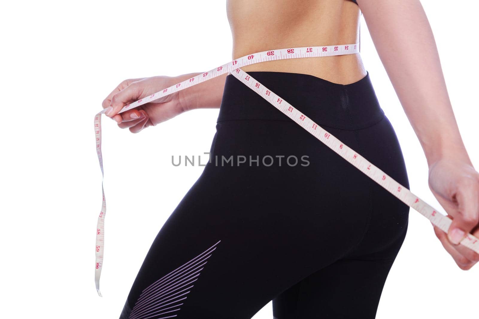 close up woman measuring waist with tape isolated on white  by geargodz