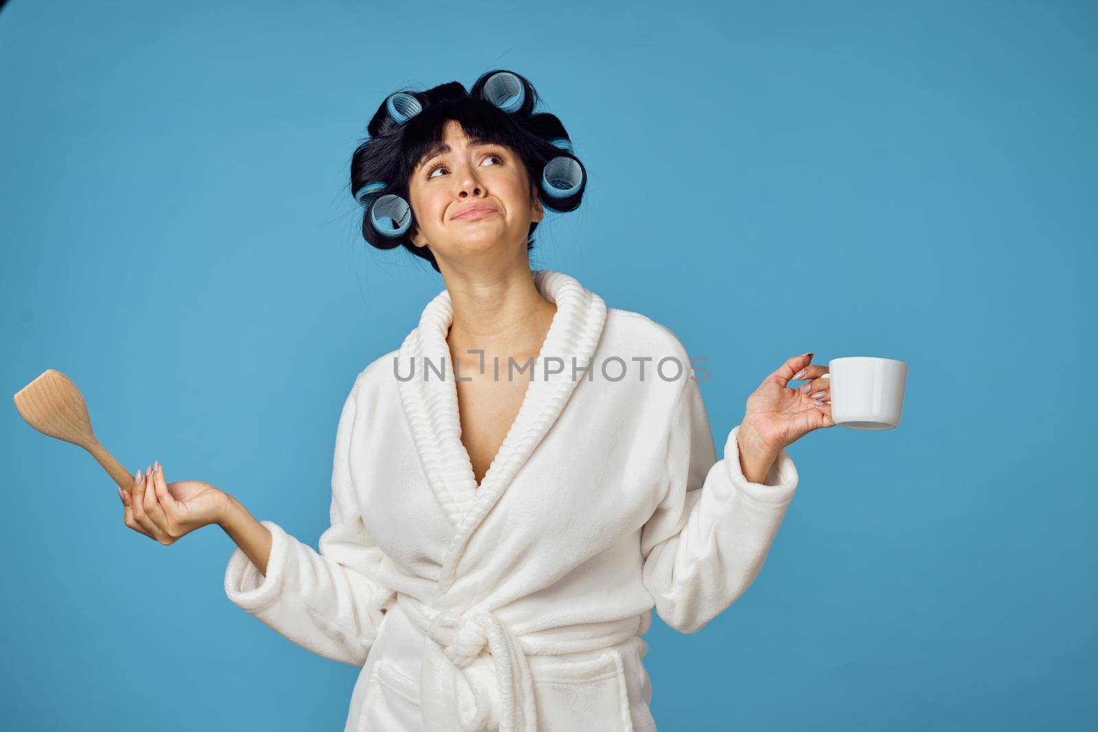 Woman in white robe kitchen utensils homework. High quality photo