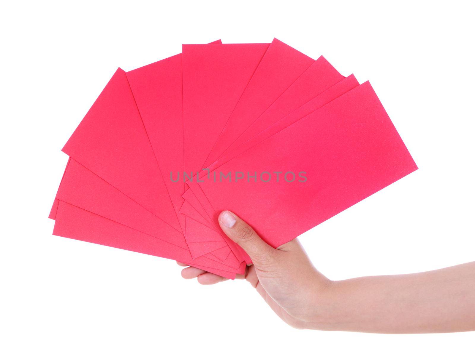 hand holding red envelope in concept of happy chinese new year isolated on a white background