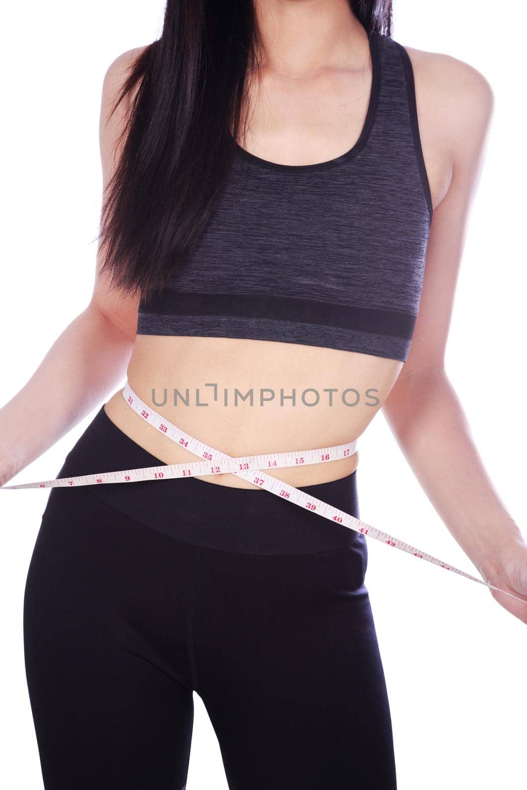 close up woman measuring waist with tape isolated on white background