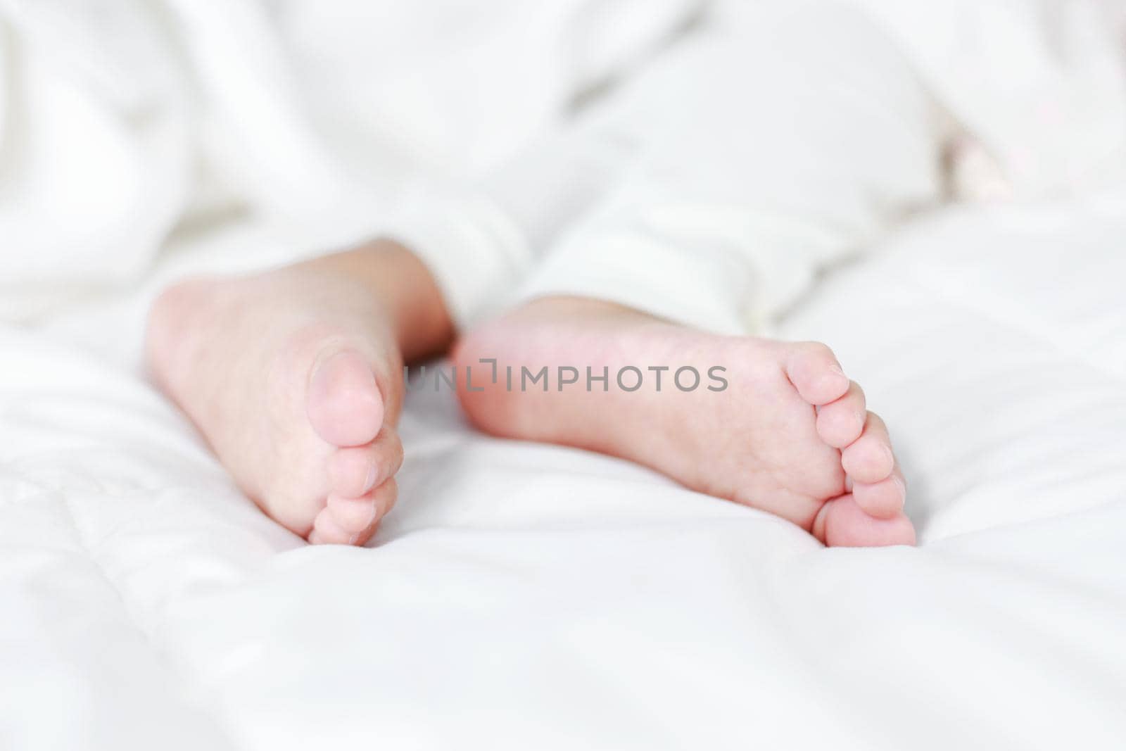 little baby feet on a bed 