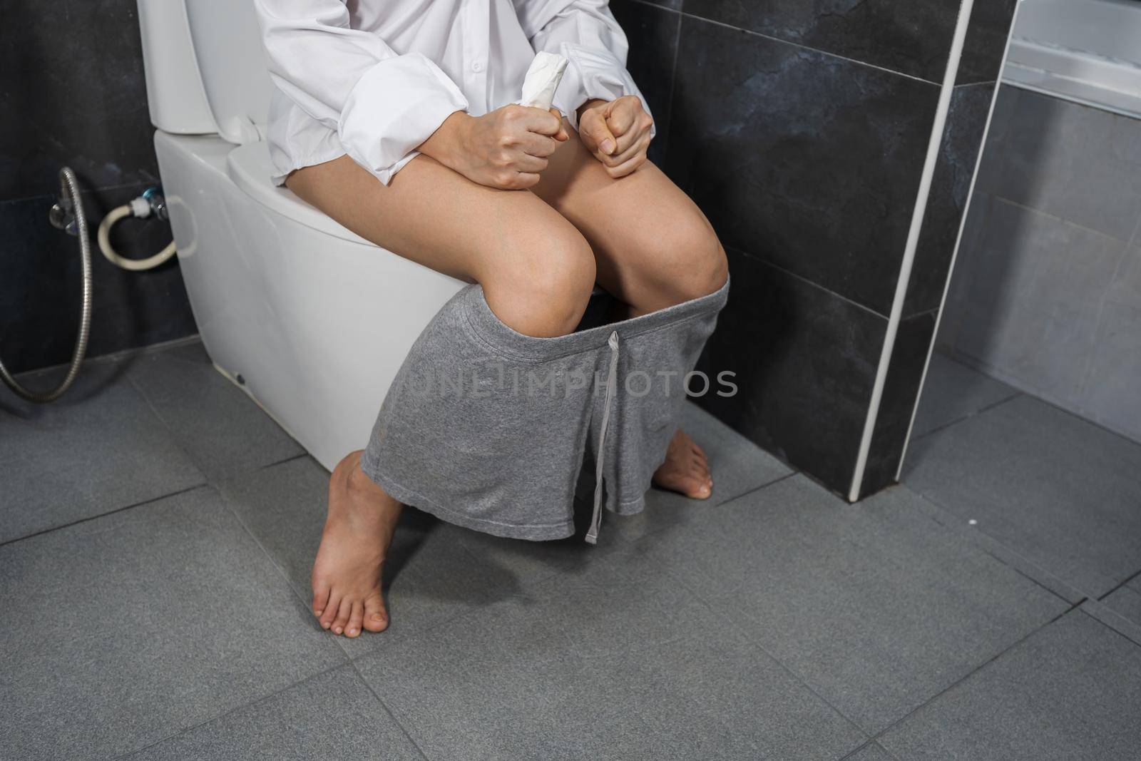 woman sitting on the toilet