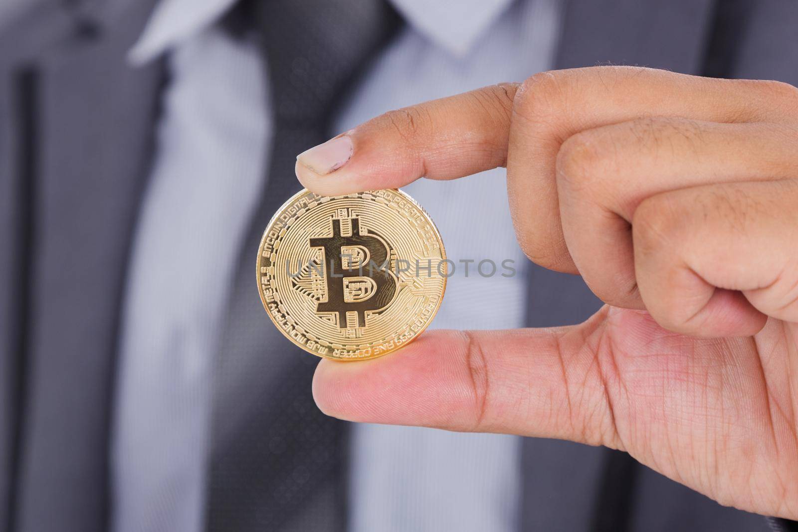 bitcoin in hand of business man by geargodz