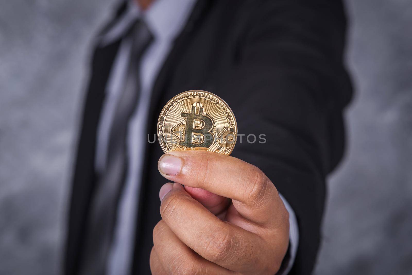 bitcoin in hand of business man by geargodz