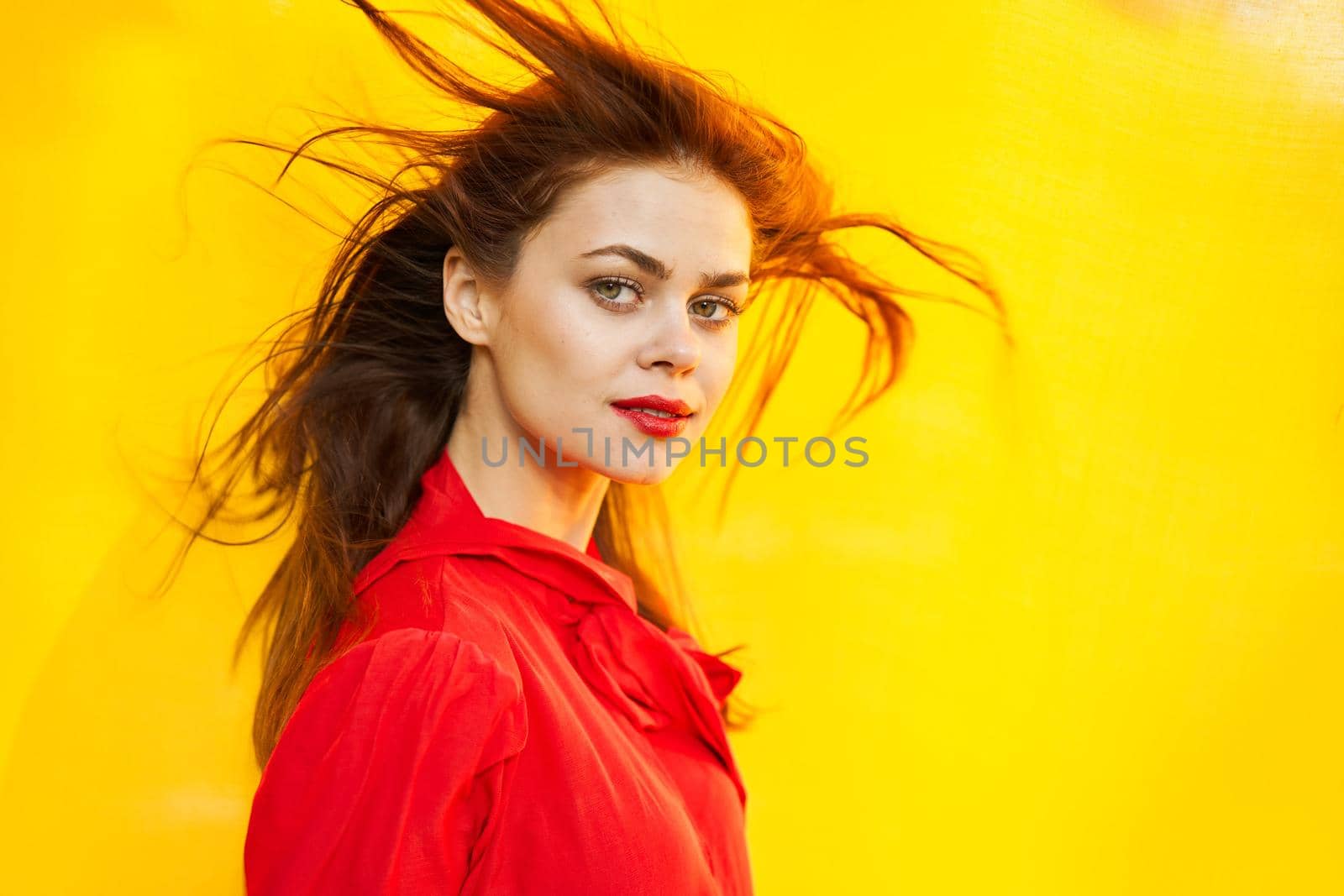 beautiful woman in red dress yellow fund posing close up. High quality photo