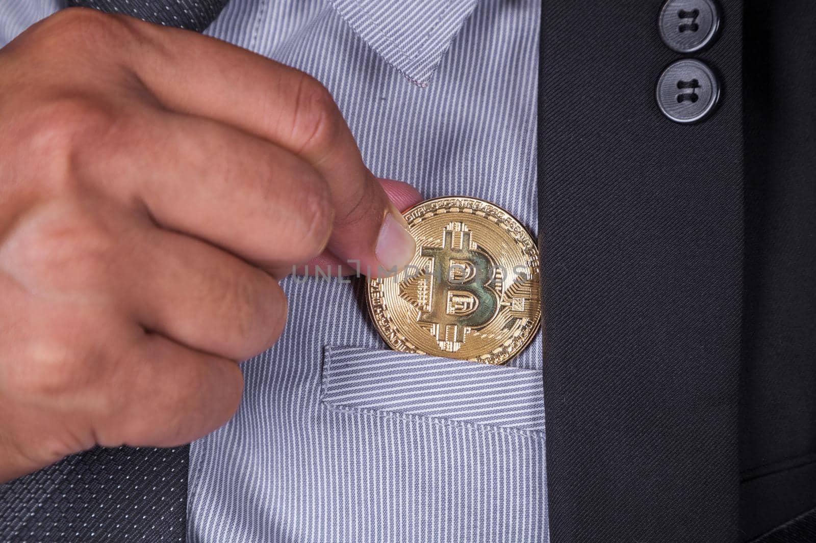 business man in suit pick bitcoin in to pocket by geargodz