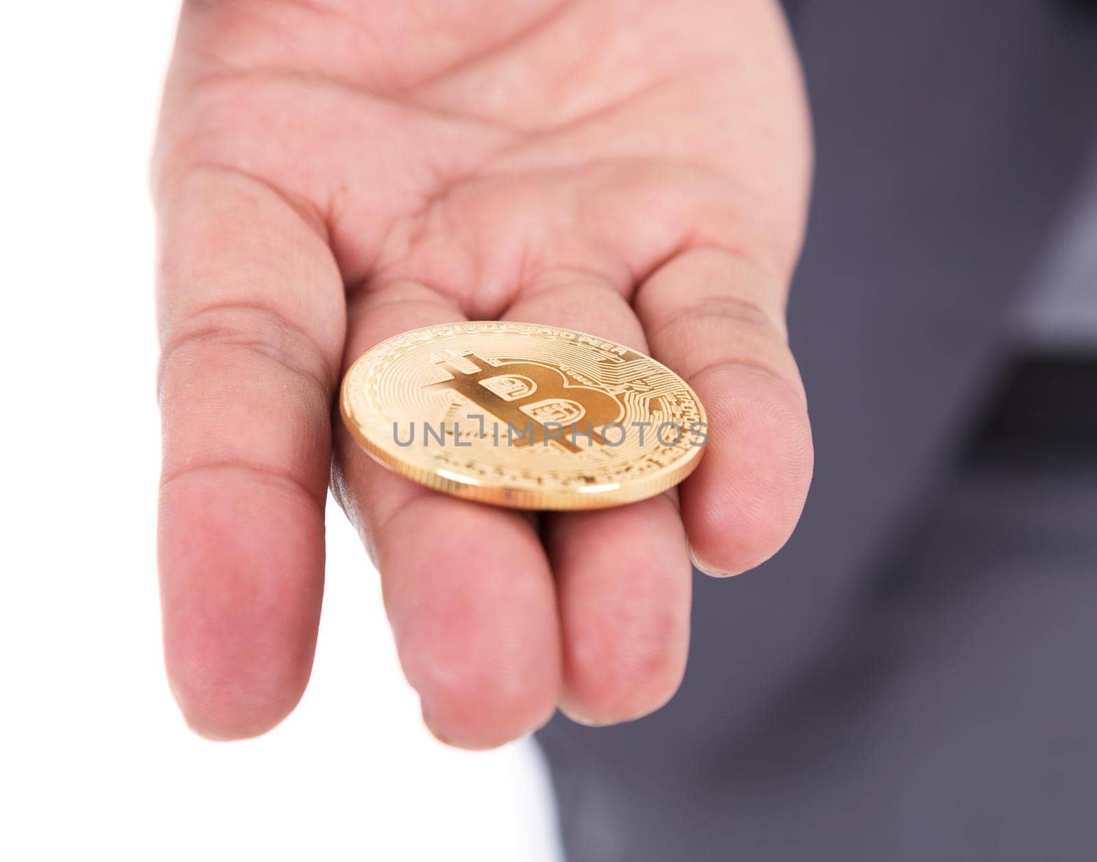 bitcoin in hand of business man with suit isolated on white background