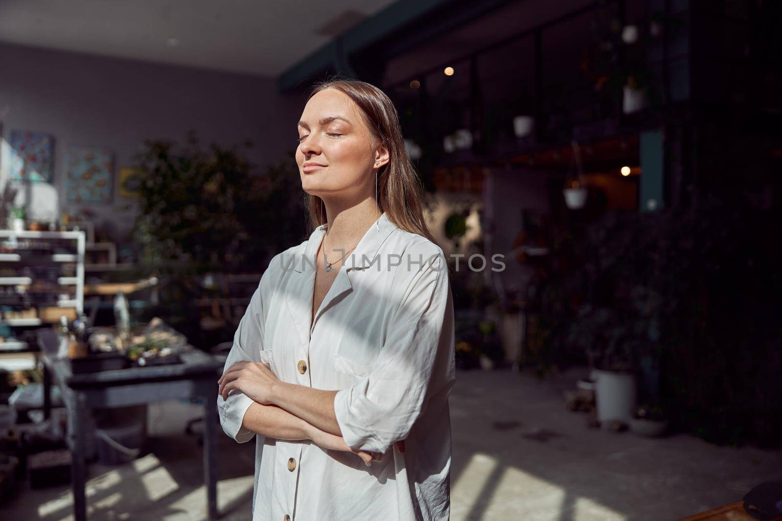 Young caucasian happy seller woman at botanic shop