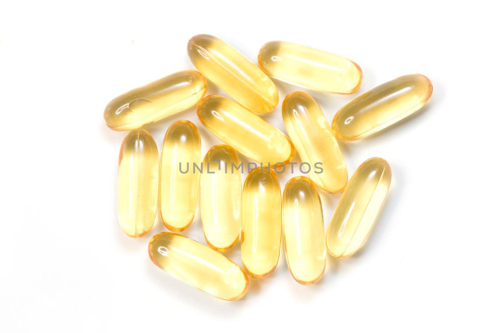 Close up golden color oil supplements in soft gel capsule, healthy product concept by whatwolf