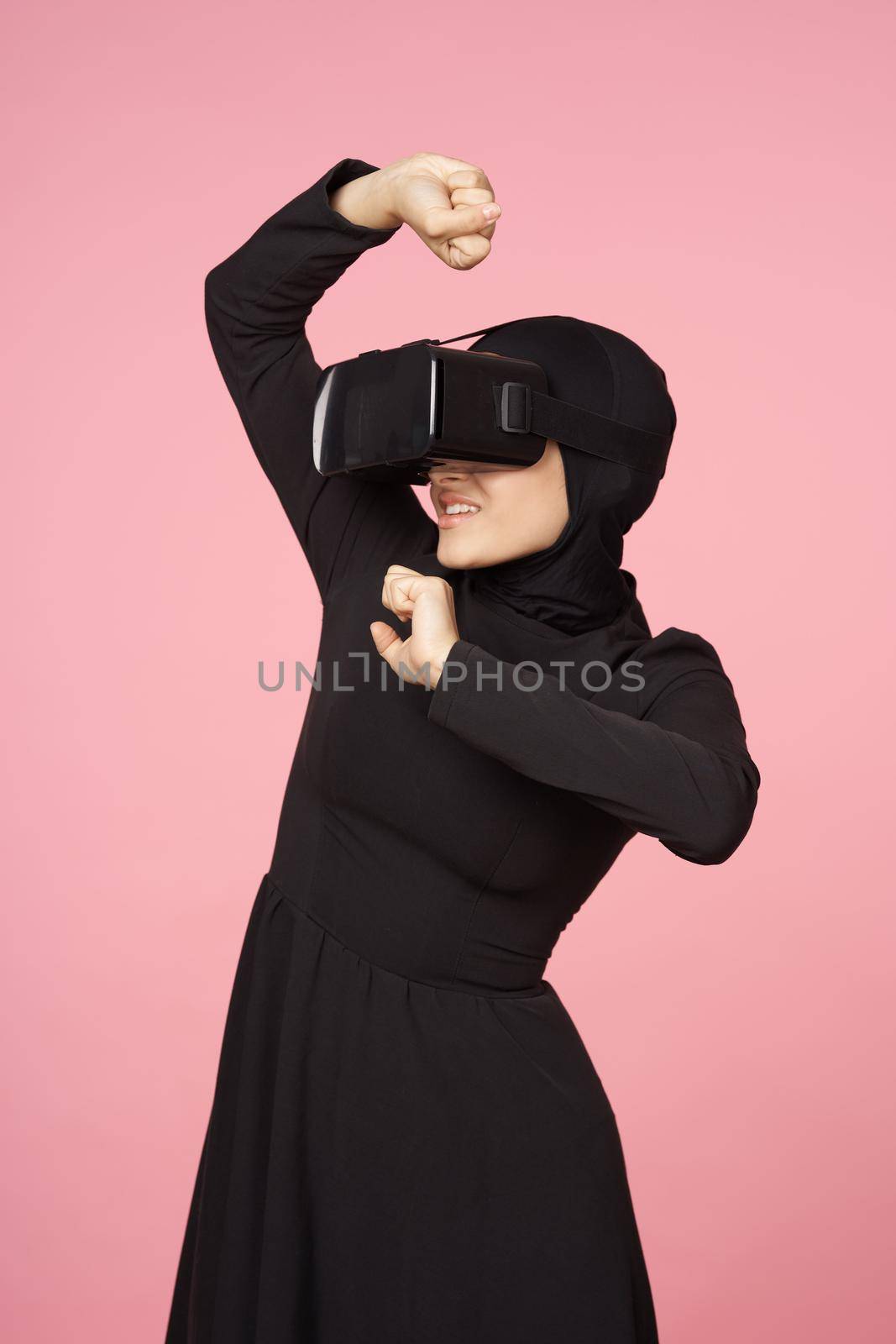 woman in black hijab glasses virtual reality technology movie watching by Vichizh