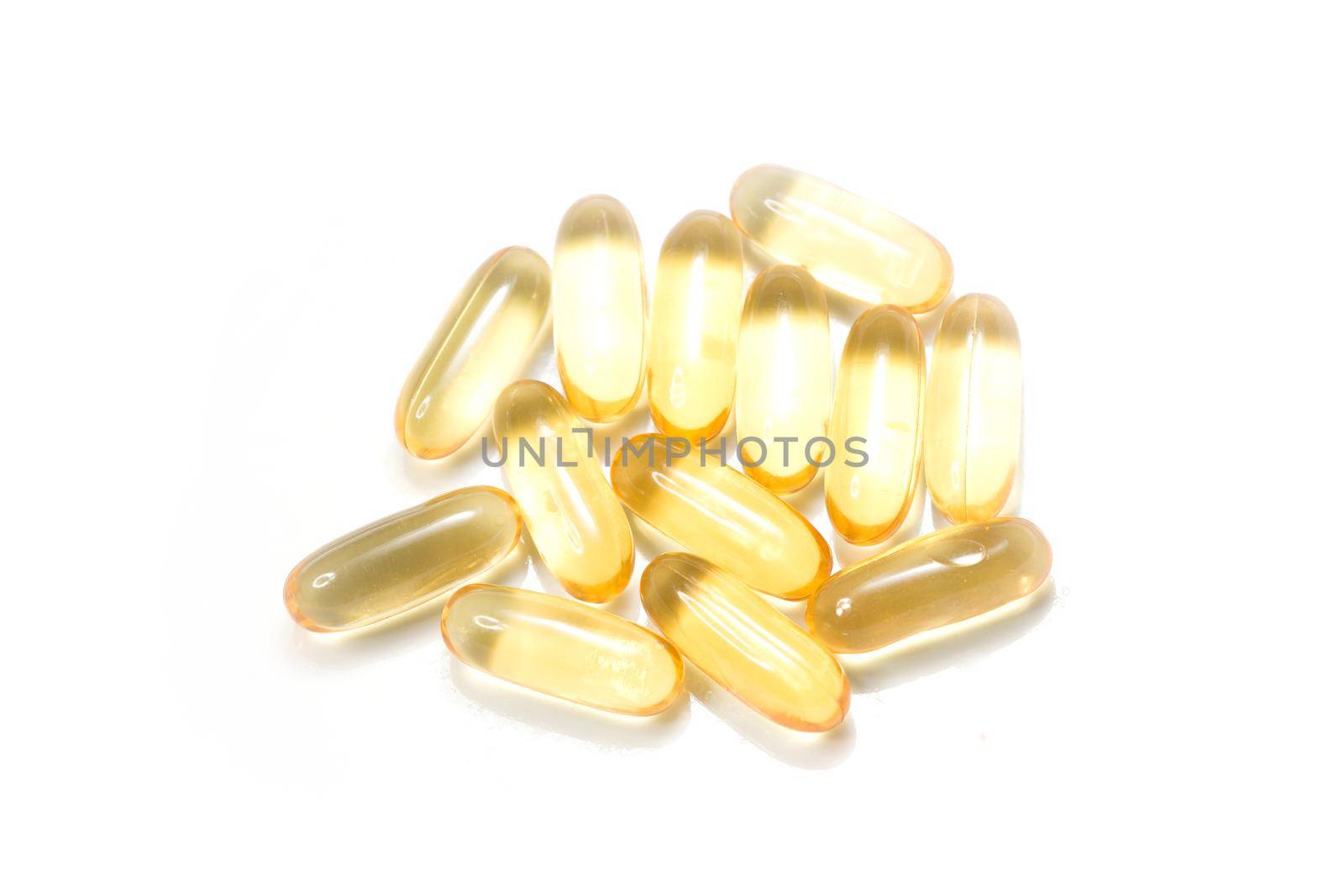 Close up golden color oil supplements in soft gel capsule, healthy product concept by whatwolf