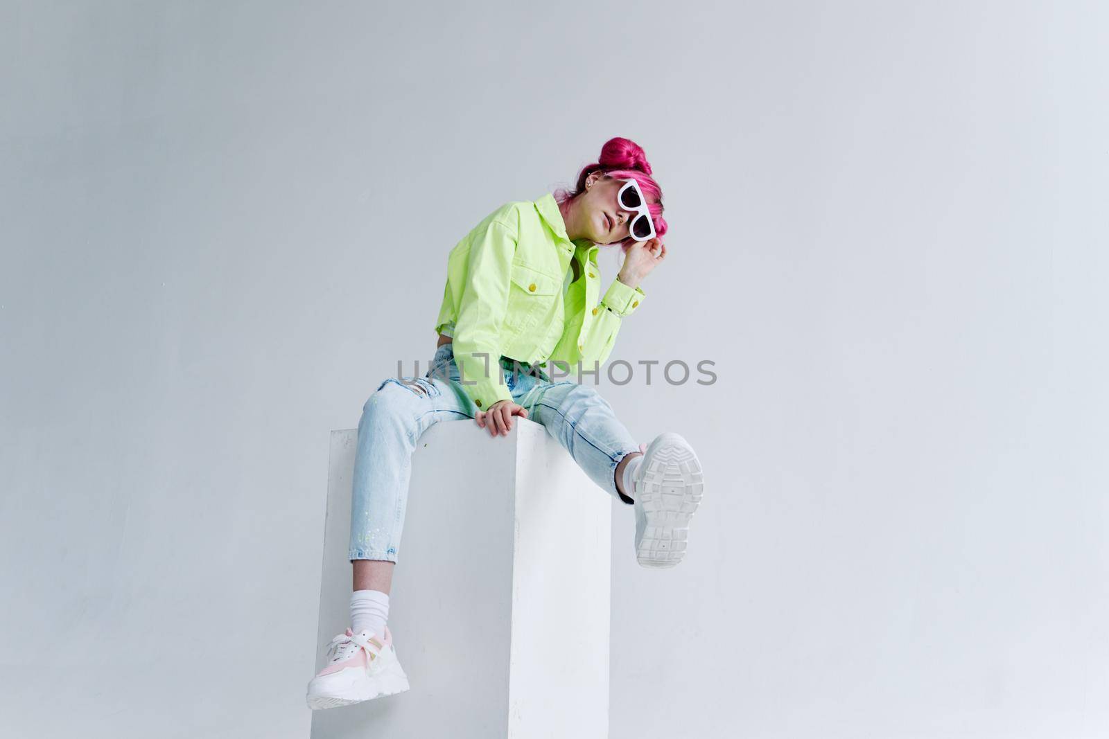 cheerful woman pink hair posing fashion clothes studio model. High quality photo