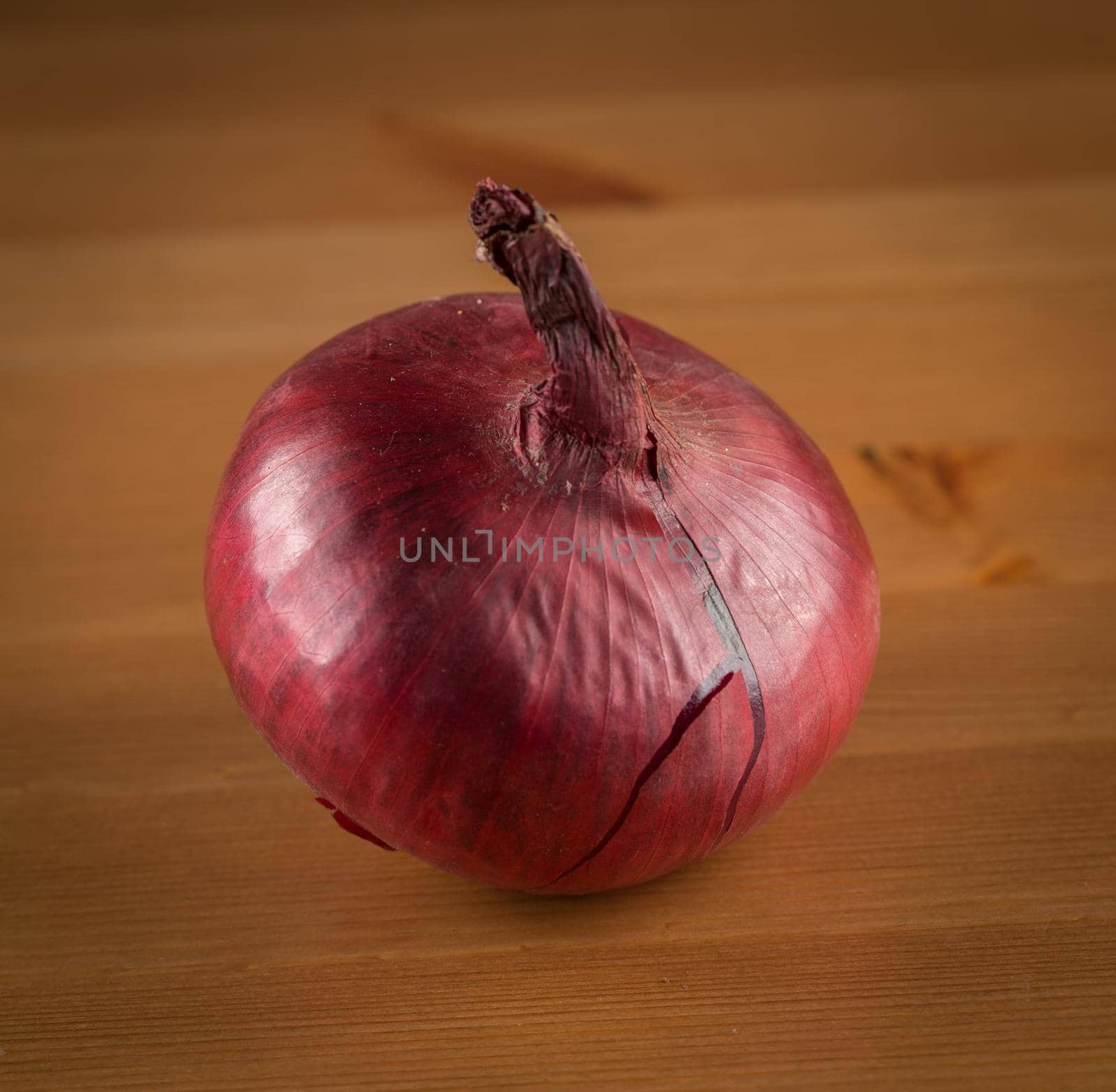 Red onion on wooden table