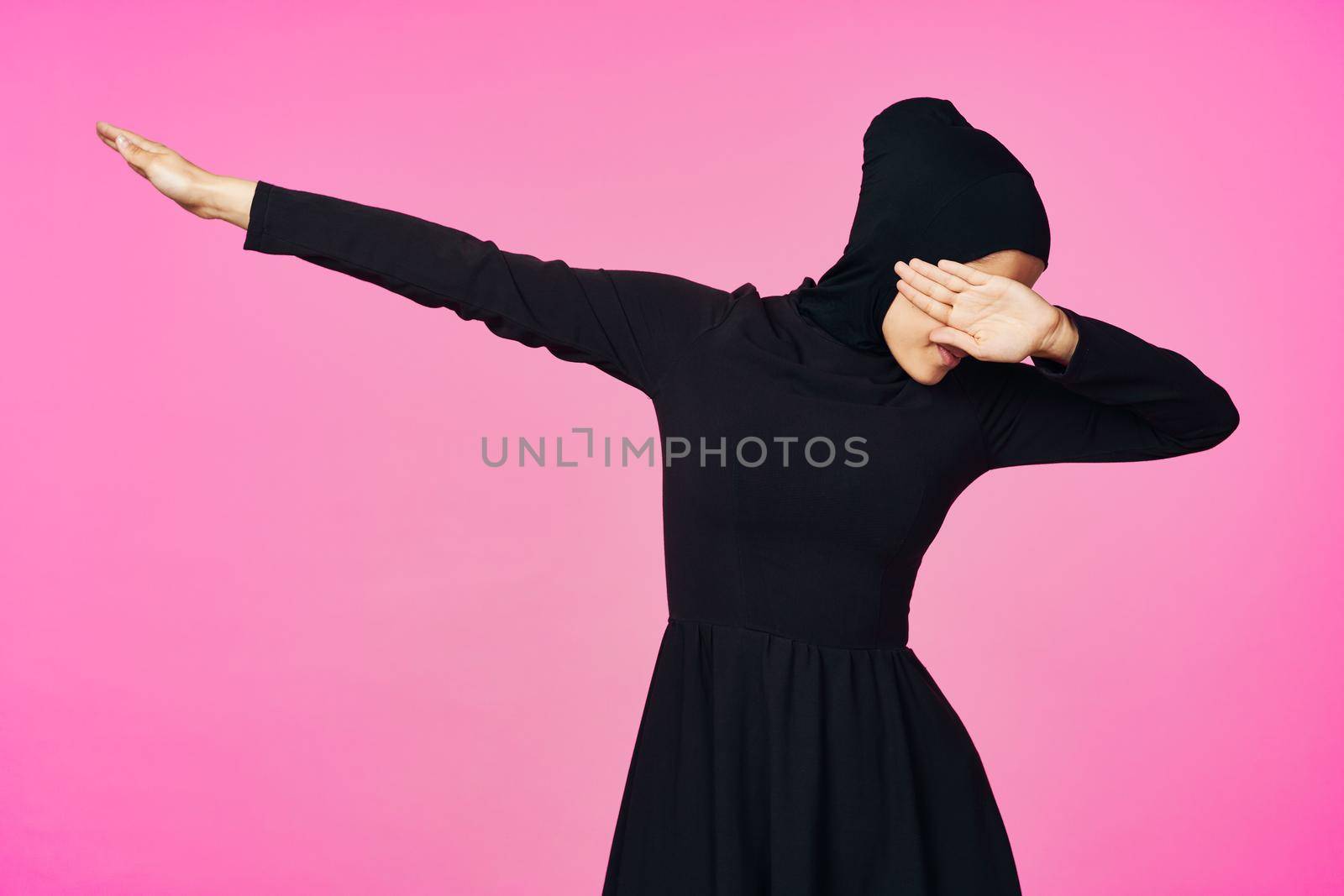 muslim woman in black hijab posing hand gesture model. High quality photo