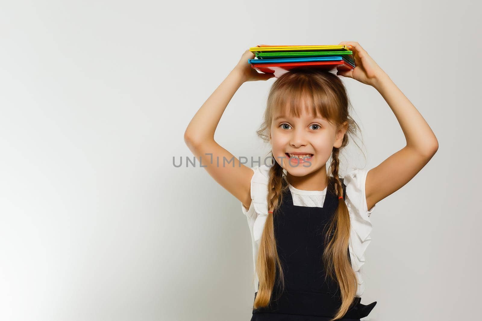 little blond school girl with backpack bag portrait isolated on white background