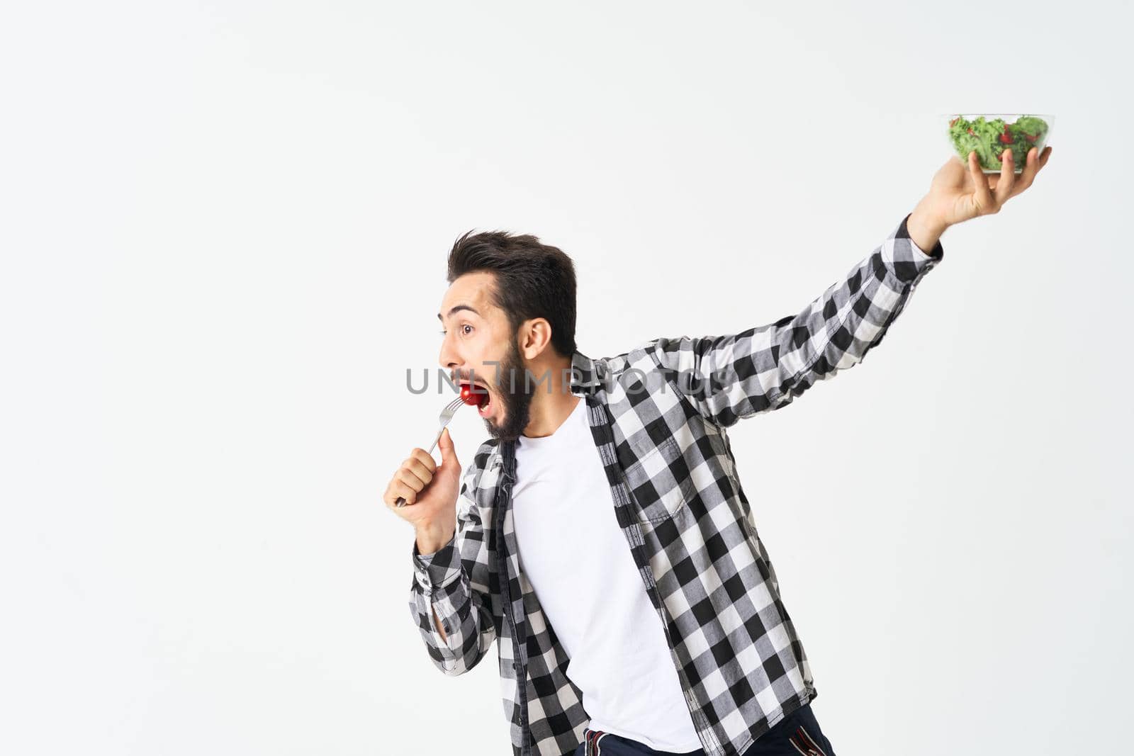 cheerful man in plaid shirt plate with salad healthy food. High quality photo