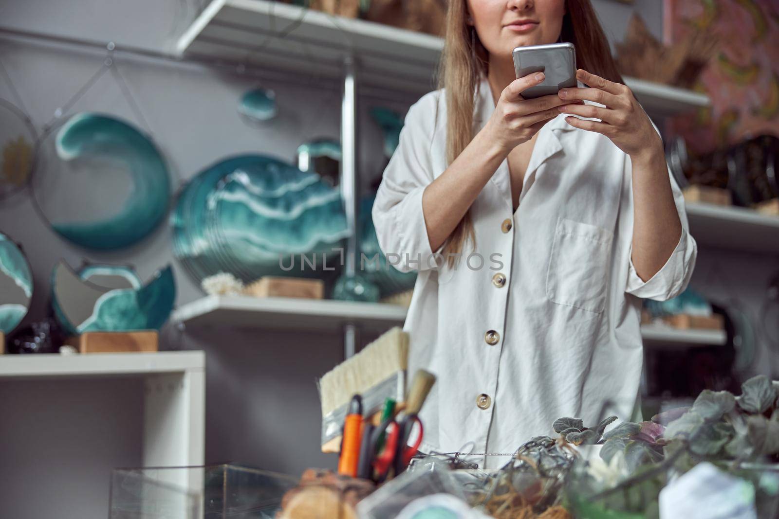 Young caucasian happy seller woman at botanic shop