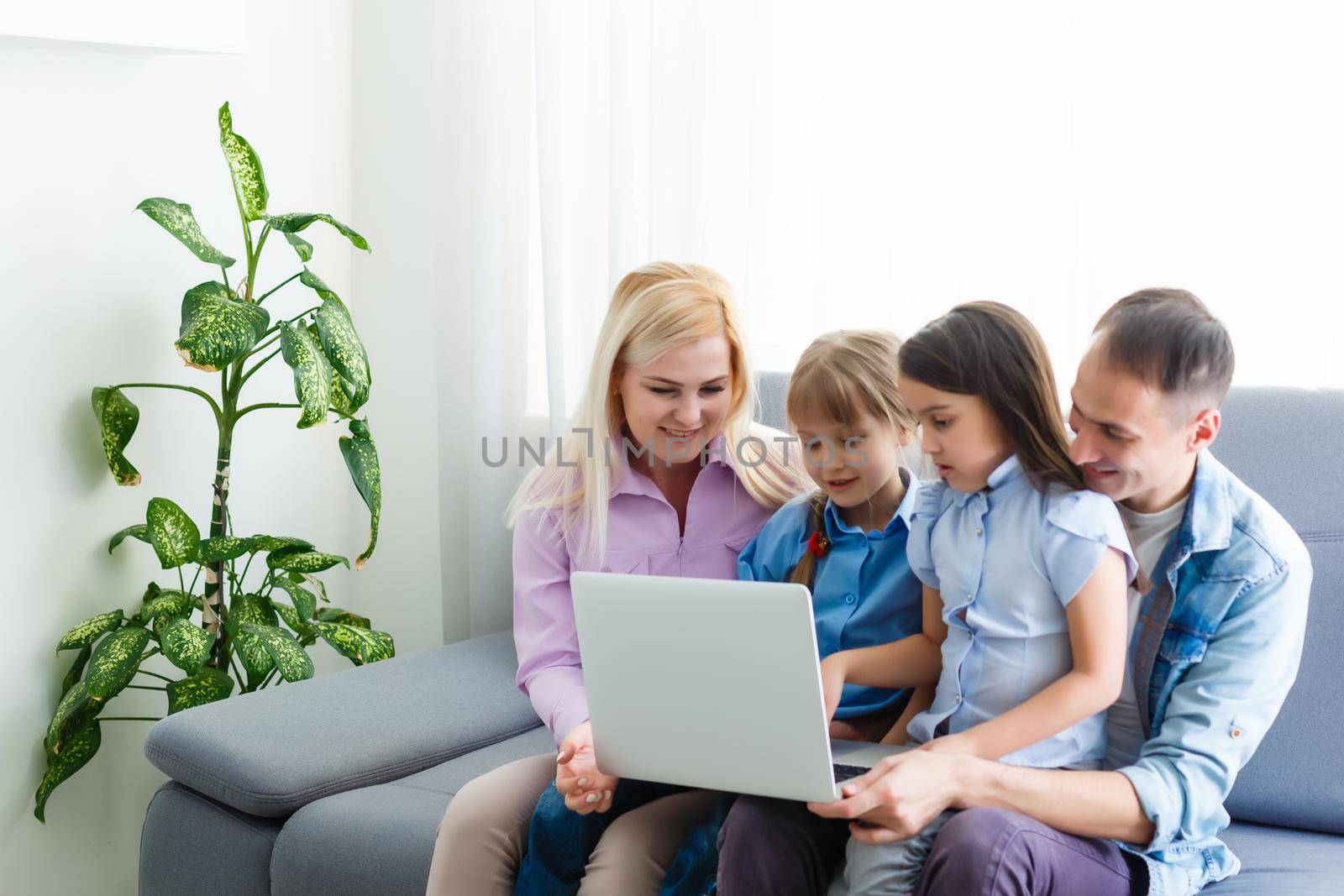 Family Working At Laptop With In Home Office by Andelov13