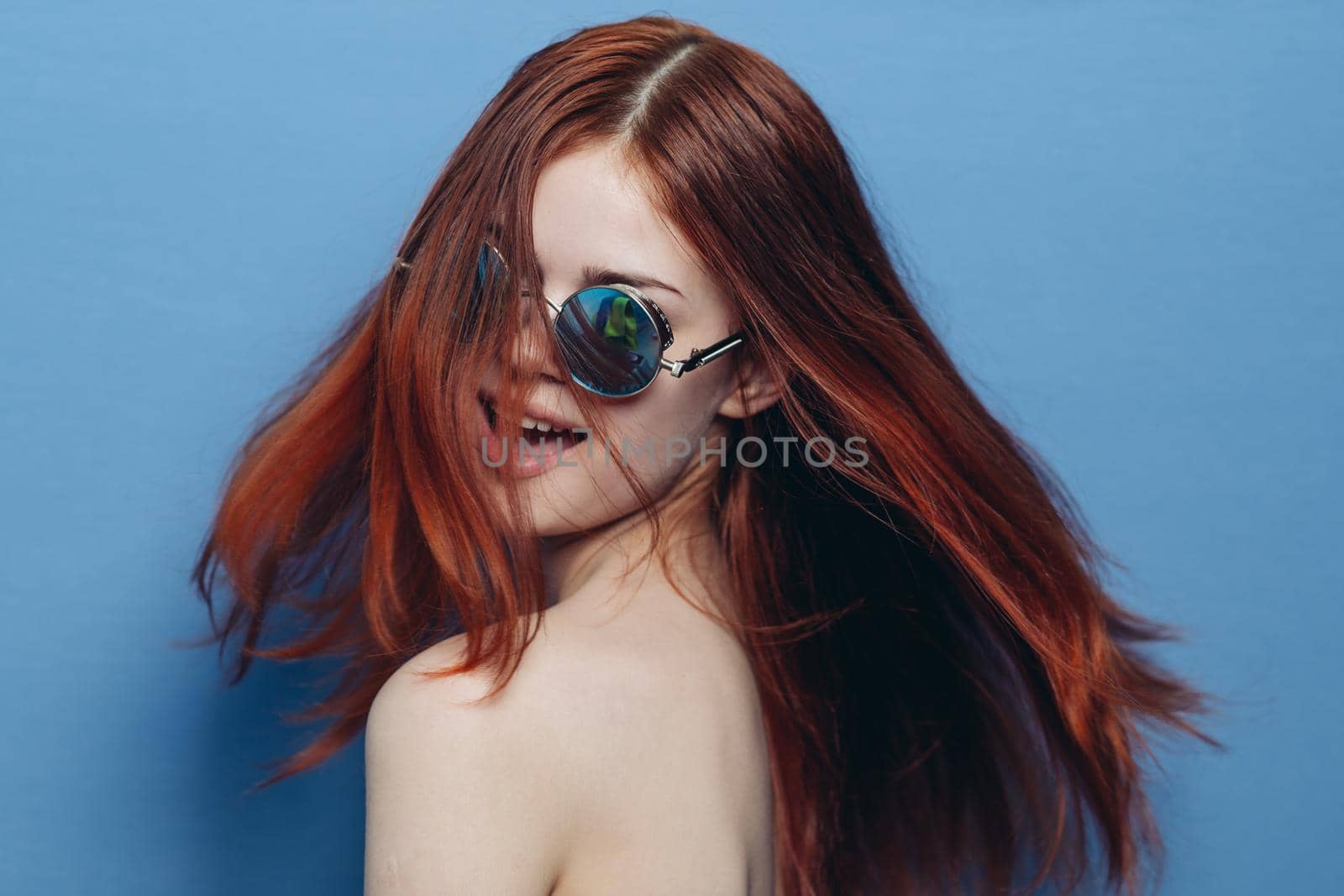 attractive woman with bare shoulders fashionable glasses blue background by Vichizh