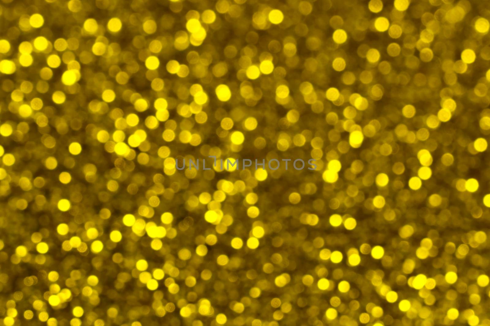Abstract shiny glitter christmas or new year background. Gold glitter background with sparkling texture. Golden shimmering light, sequins sparks and glittering glow foil background.