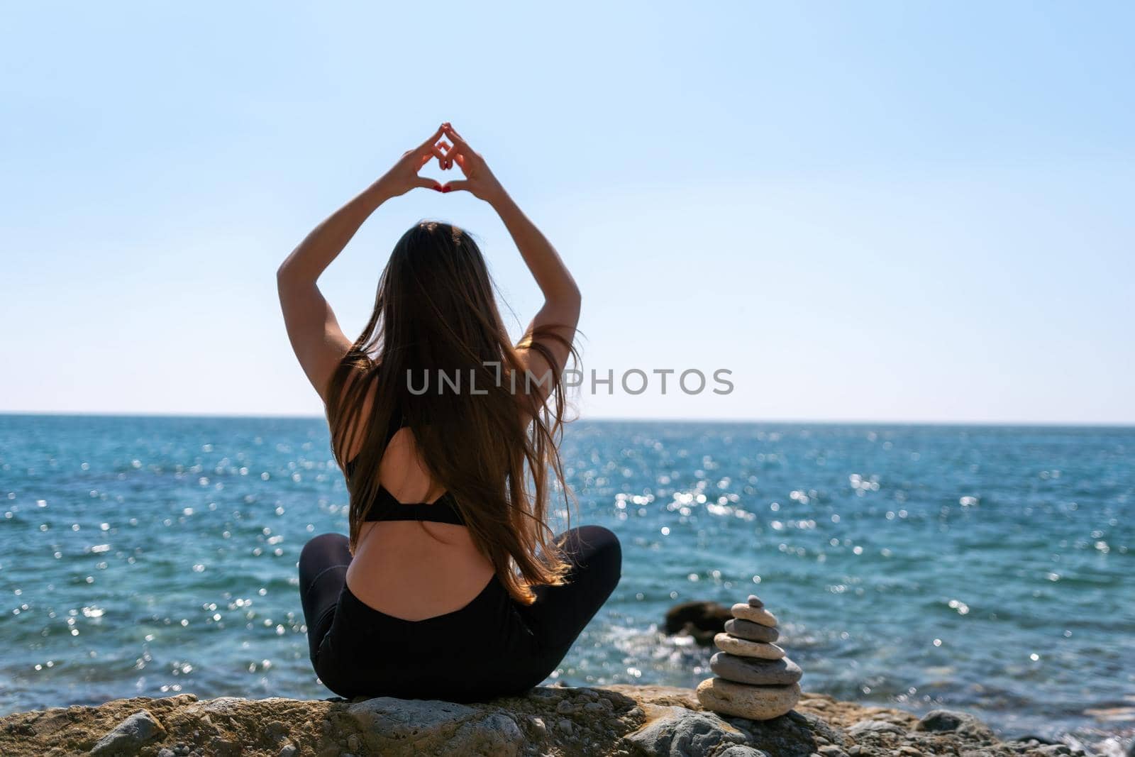 Group of young womans fitness instructor in Sportswear Leggings and Tops, stretching in the gym before pilates, on a yoga mat near the large window on a sunny day, female fitness yoga routine concept.