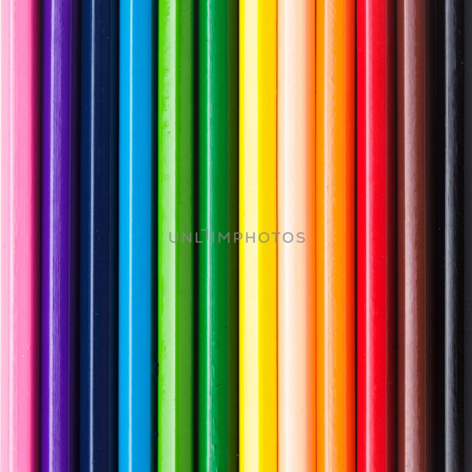 Rainbow color pencils in a row as a background