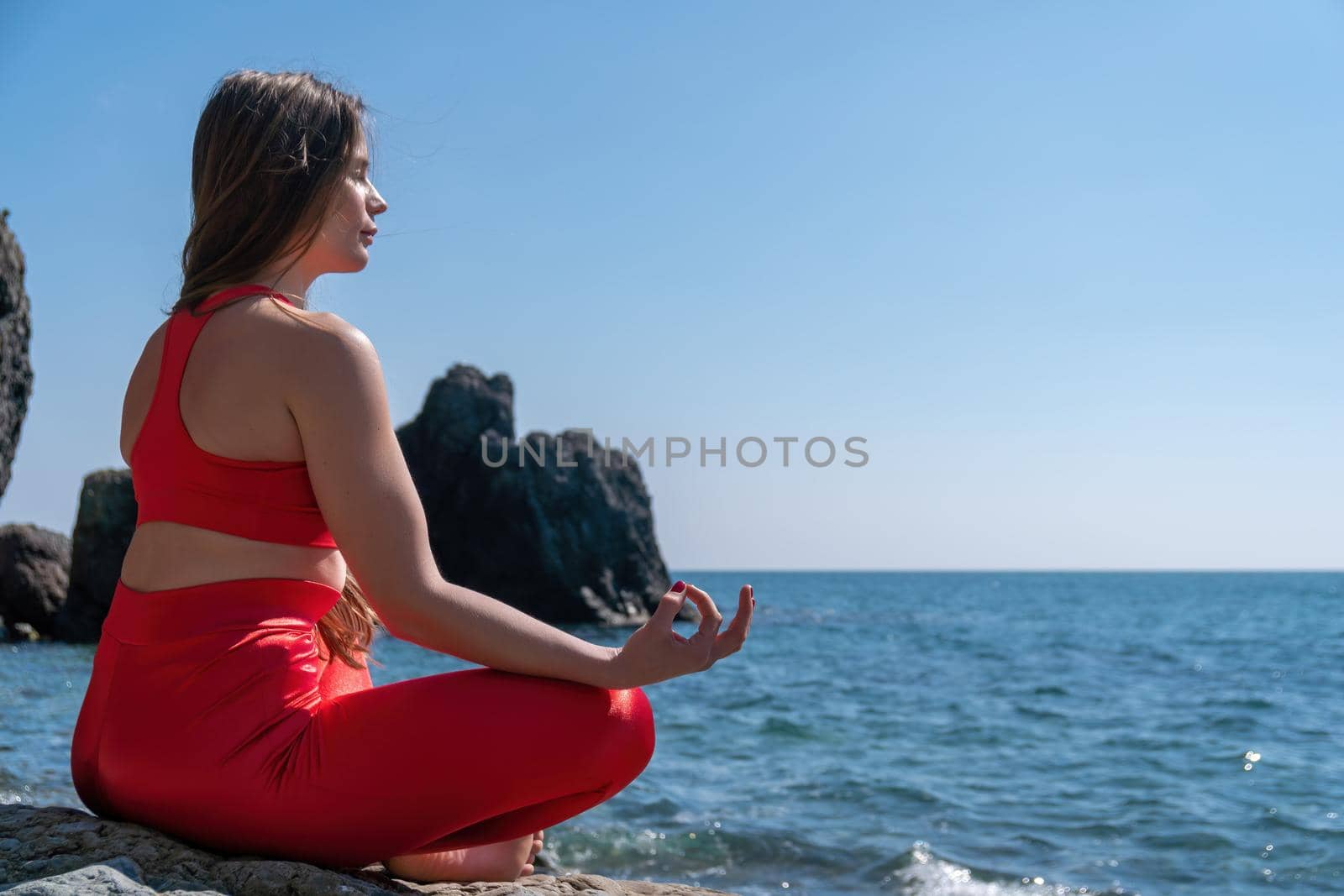 Group of young womans fitness instructor in Sportswear Leggings and Tops, stretching in the gym before pilates, on a yoga mat near the large window on a sunny day, female fitness yoga routine concept.