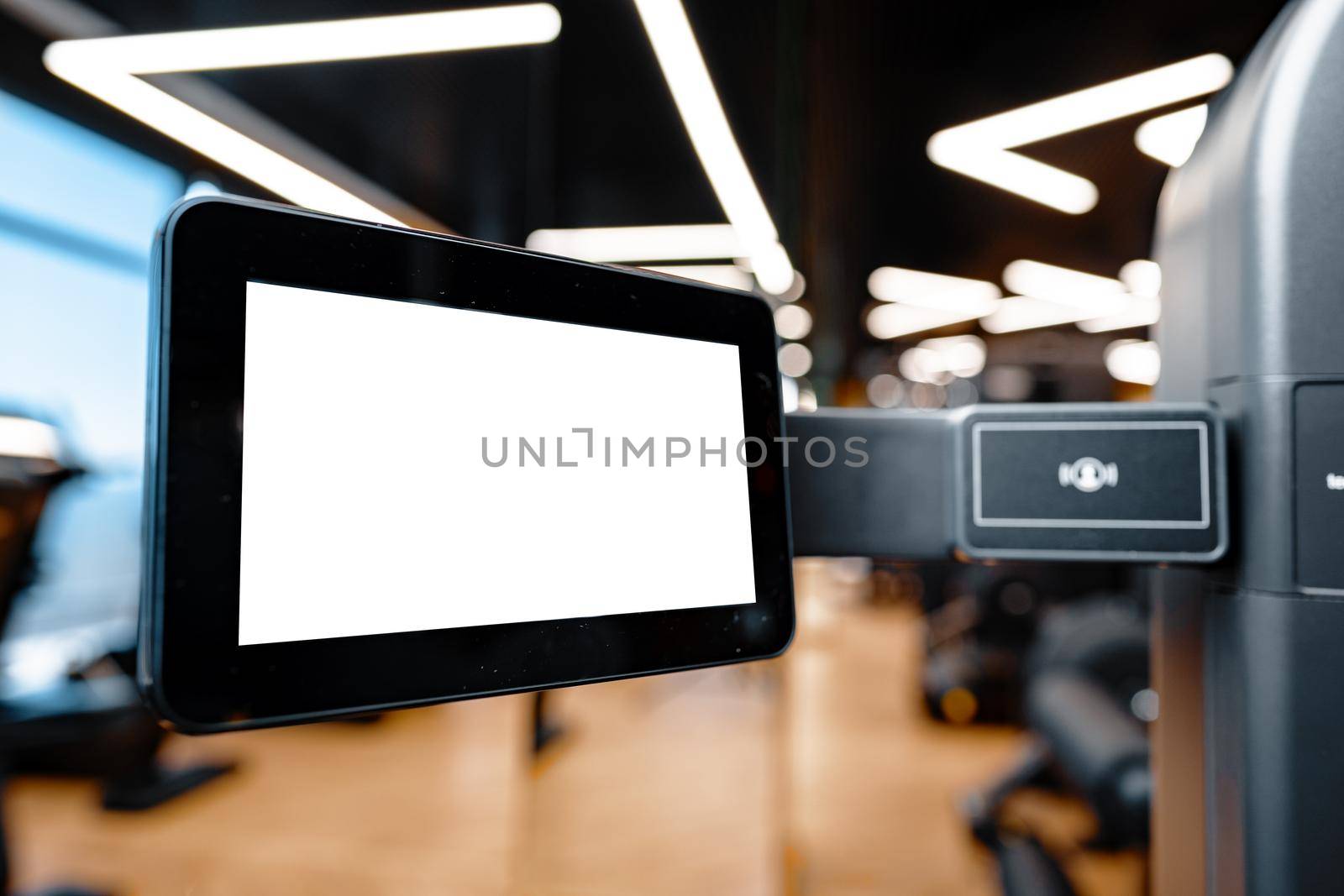 Close up of white screen on gym apparatus in a luxury gym, copy space