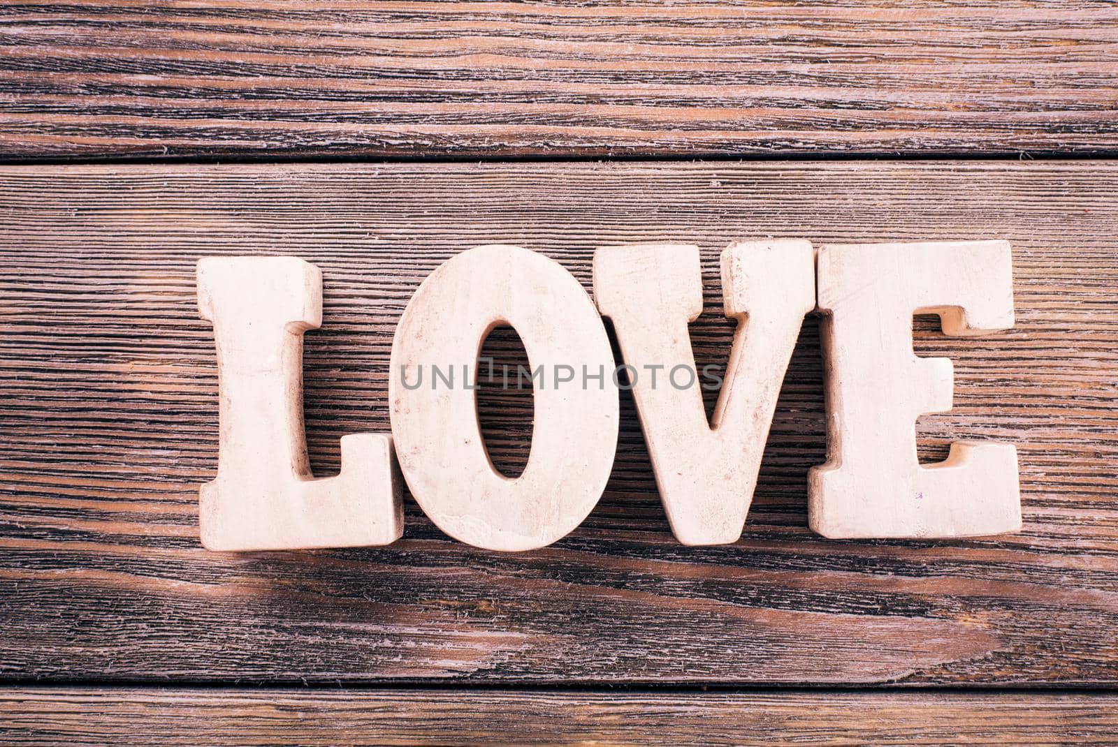 Wooden letters LOVE on a wooden background