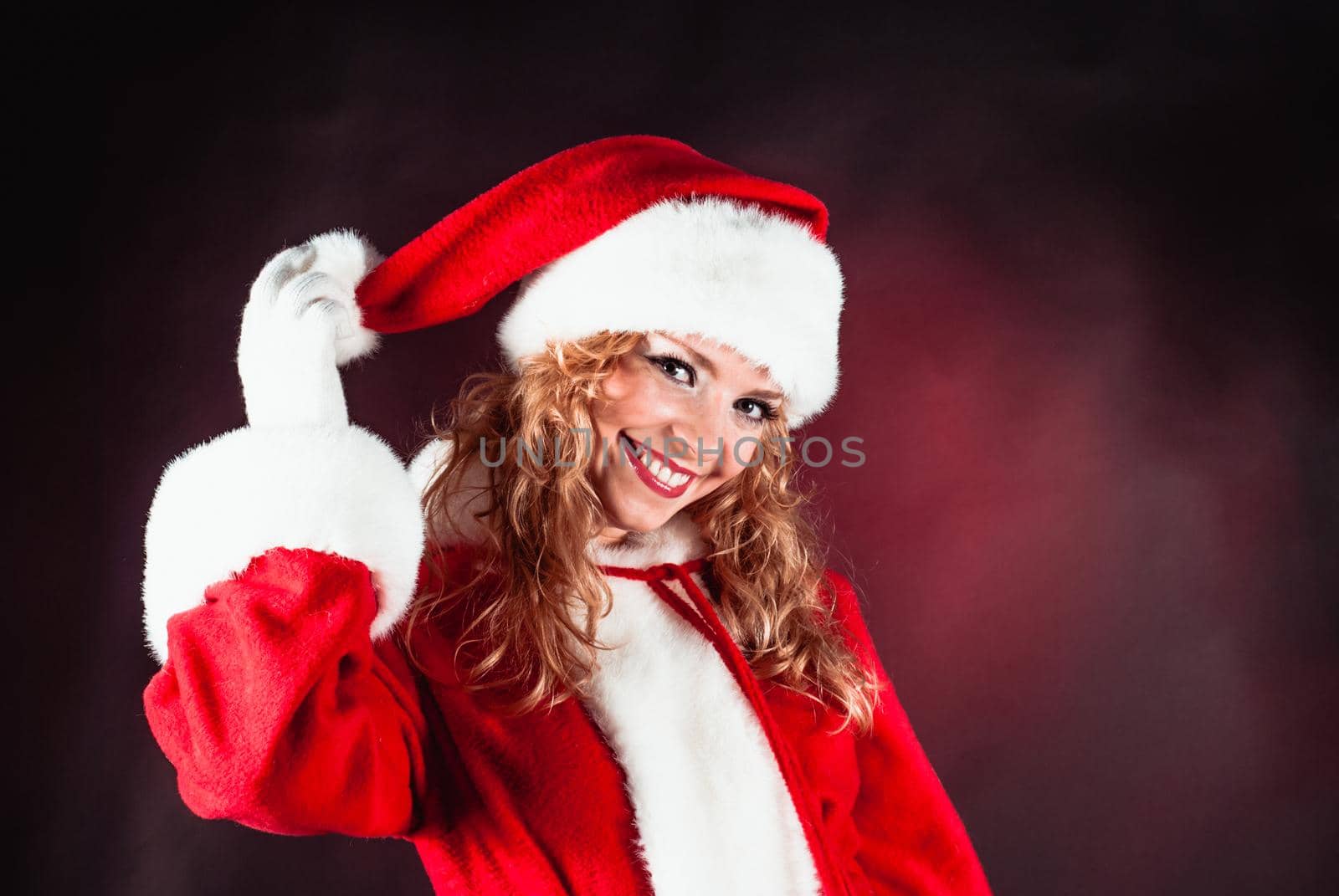 Santa girl face on the red black background