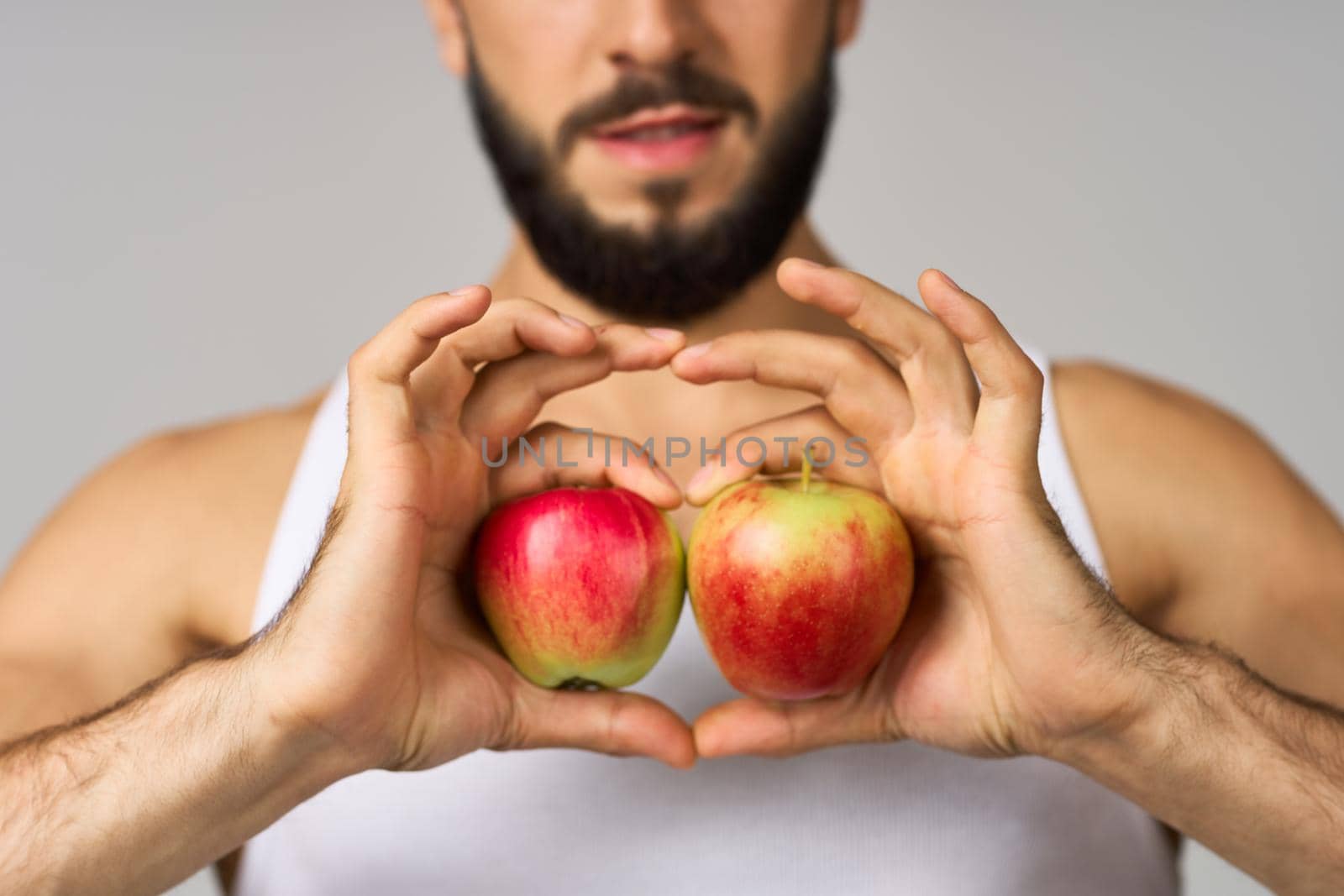 Cheerful man fresh fruit apples vitamins studio lifestyle. High quality photo