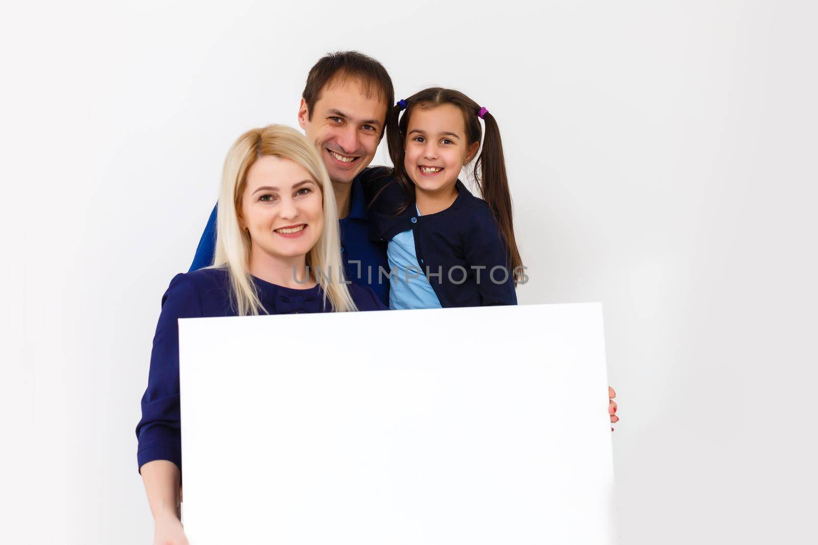 family holds holds a large photo canvas
