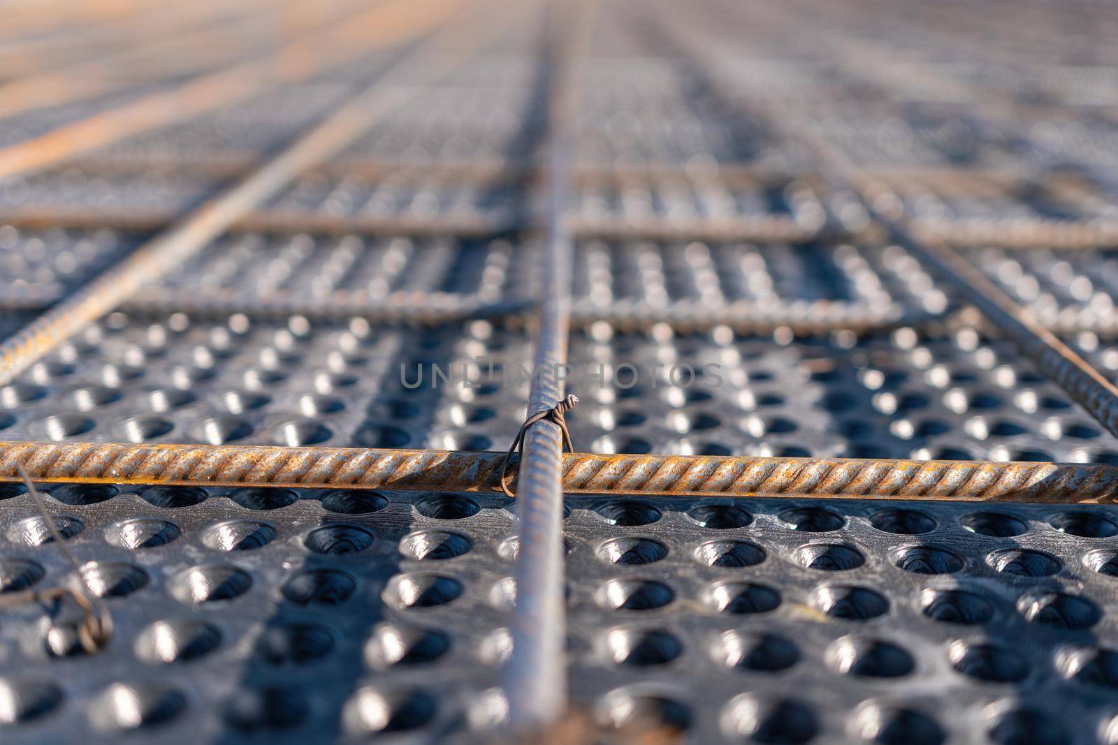 Close up view of reinforcement of concrete. Geometric alignment of Rebars on construction site. Reinforcements steel bars stack