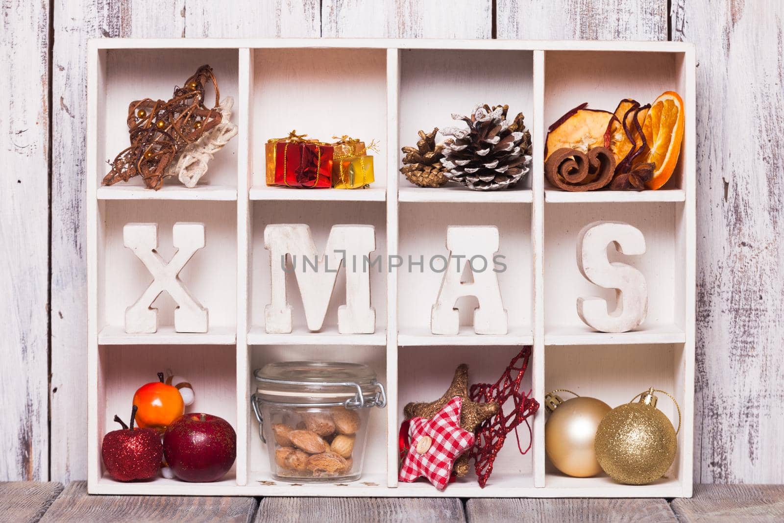 Christmas decoration in a wooden box. Cozy holiday in home. Wood letters XMAS in shadow box memories