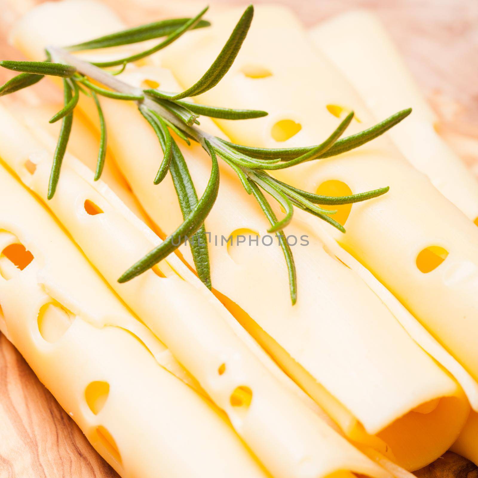 provolone dolce cheese slices on a wooden board