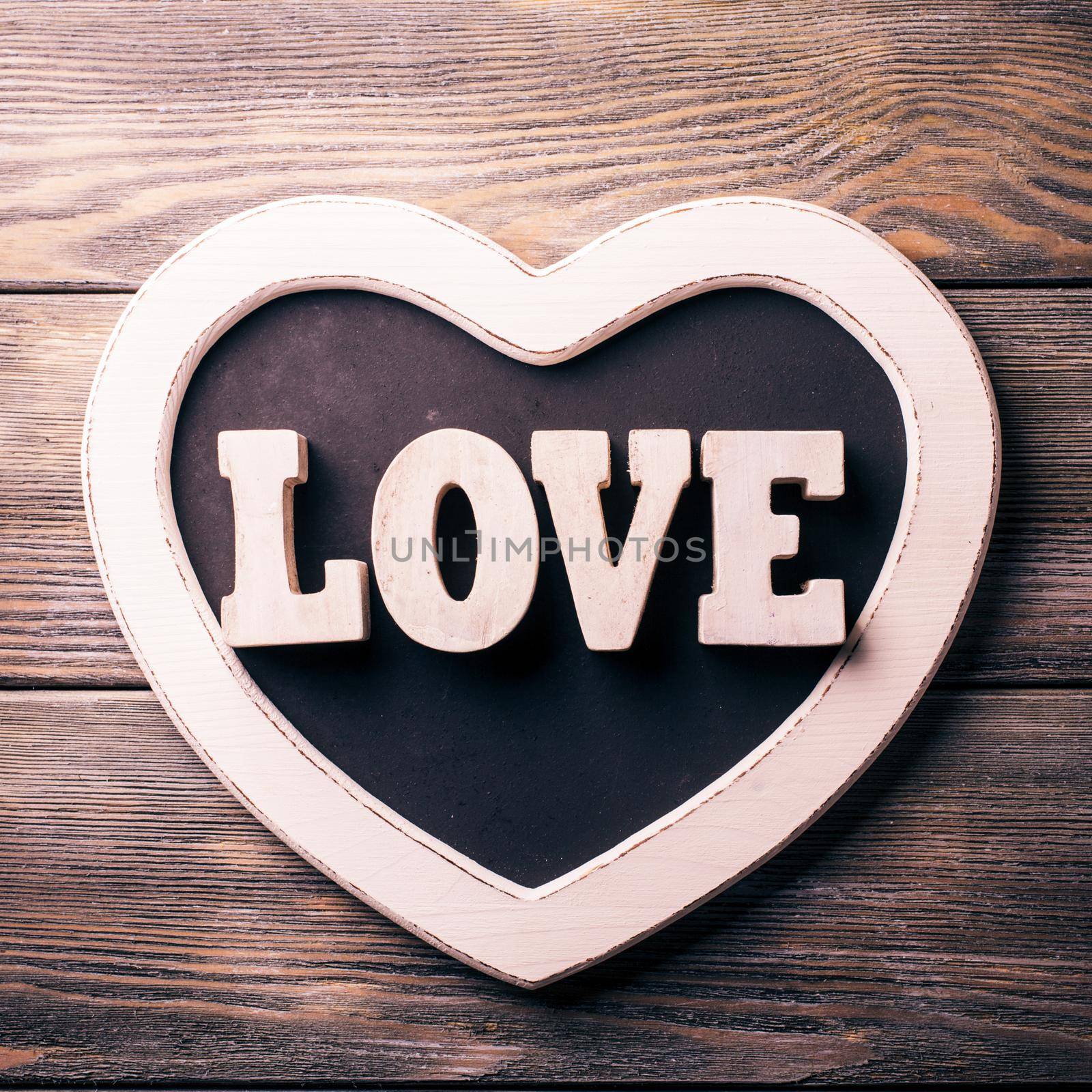 Wooden letters LOVE on heart shape chalkboard