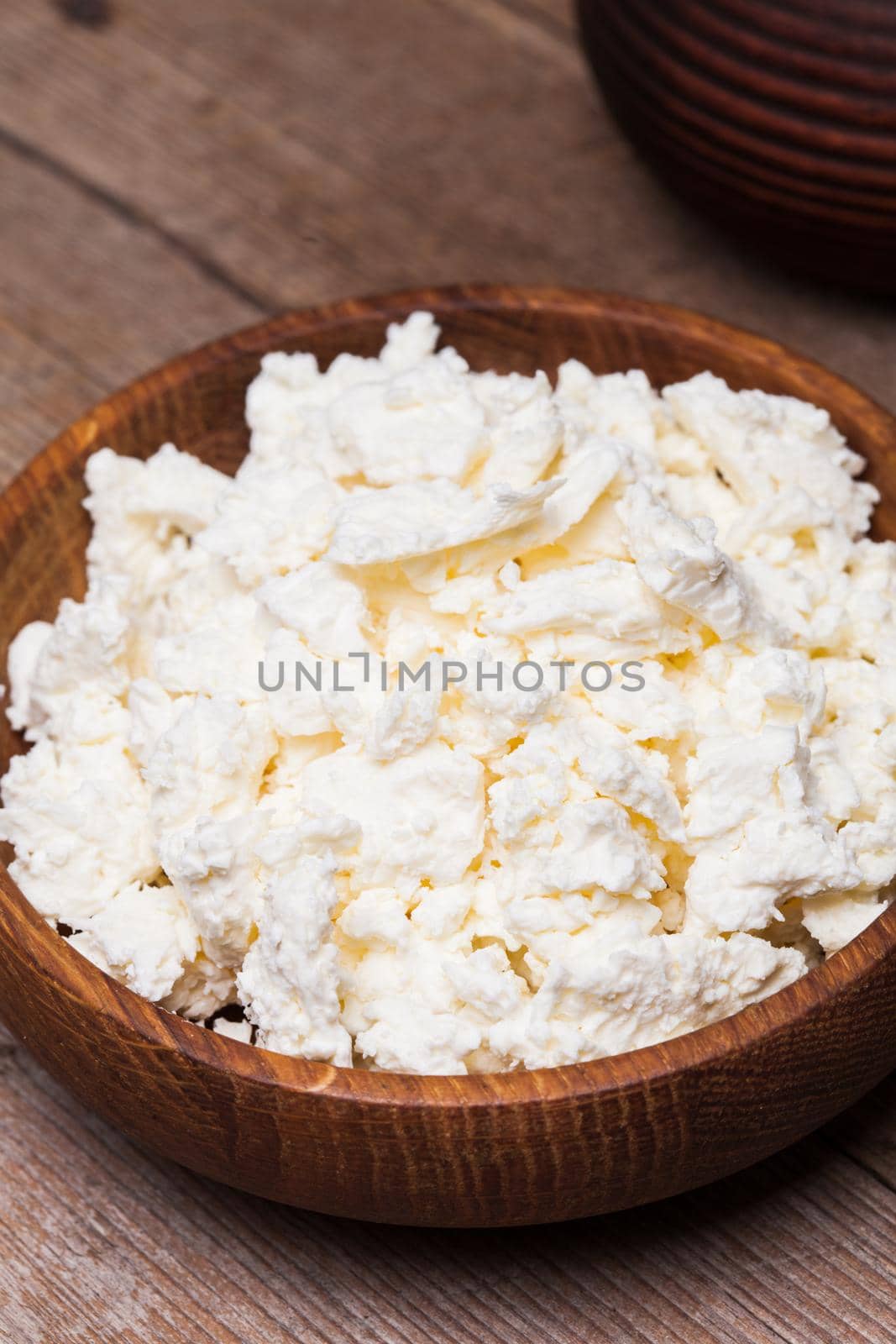 cottage cheese or curd in a wooden bowl
