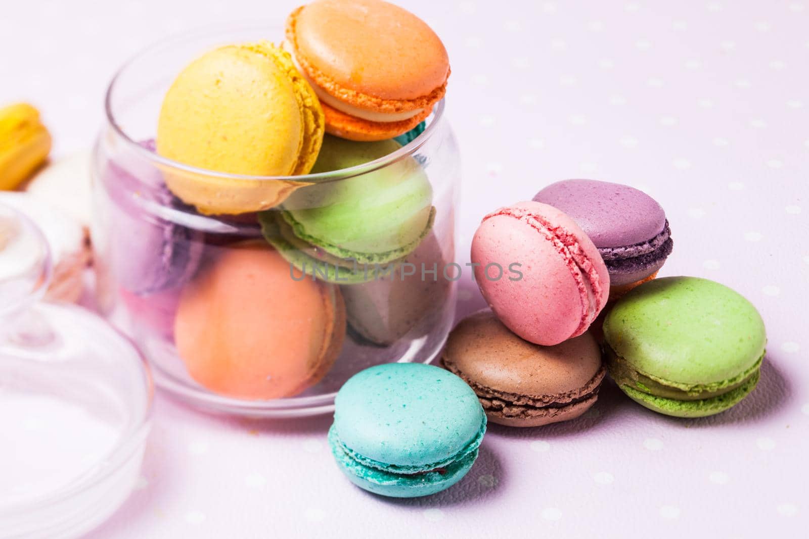 Colorful macaroons - french dessert in a glass jar