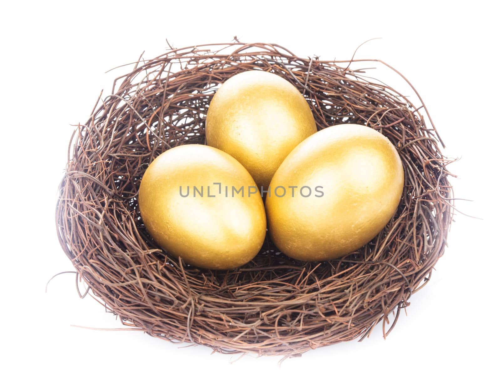 Three golden eggs in the nest isolated on white