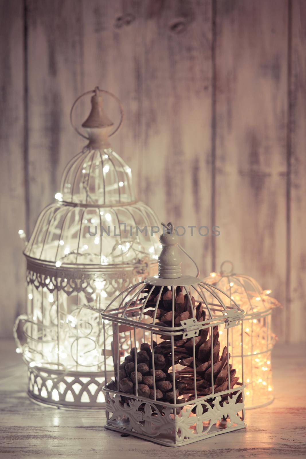 Christmas light decoration in a white bird cage.