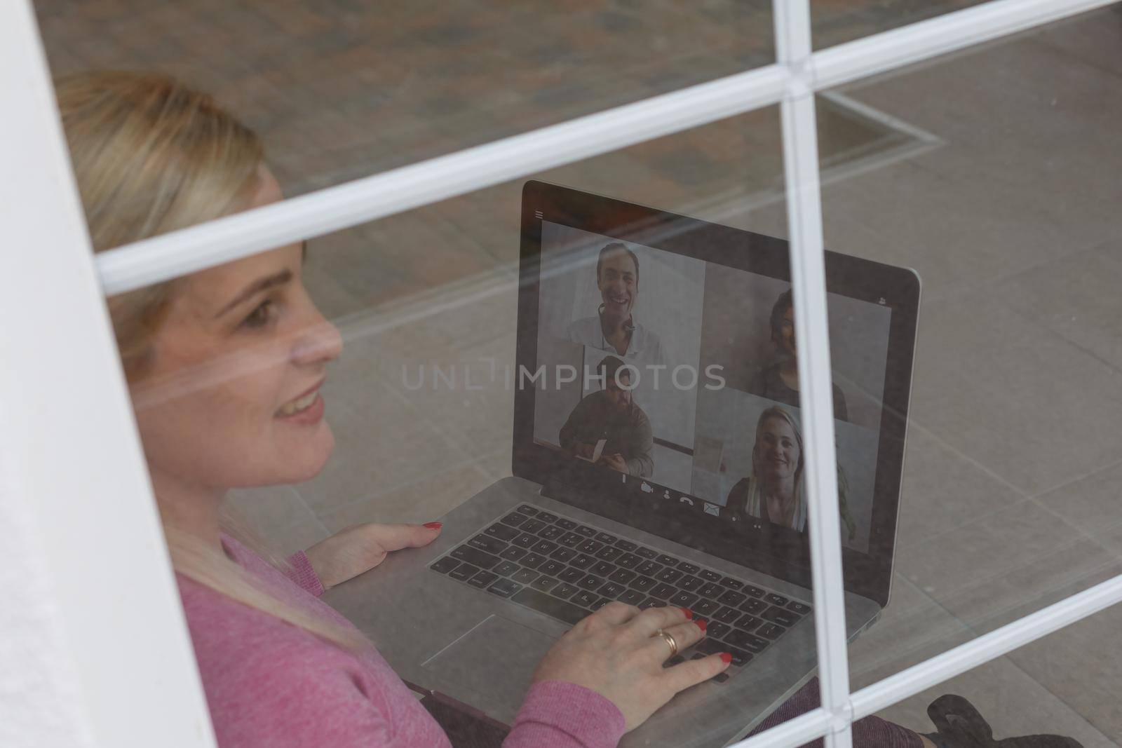 Woman Working From Home Having Group Videoconference On Laptop by Andelov13