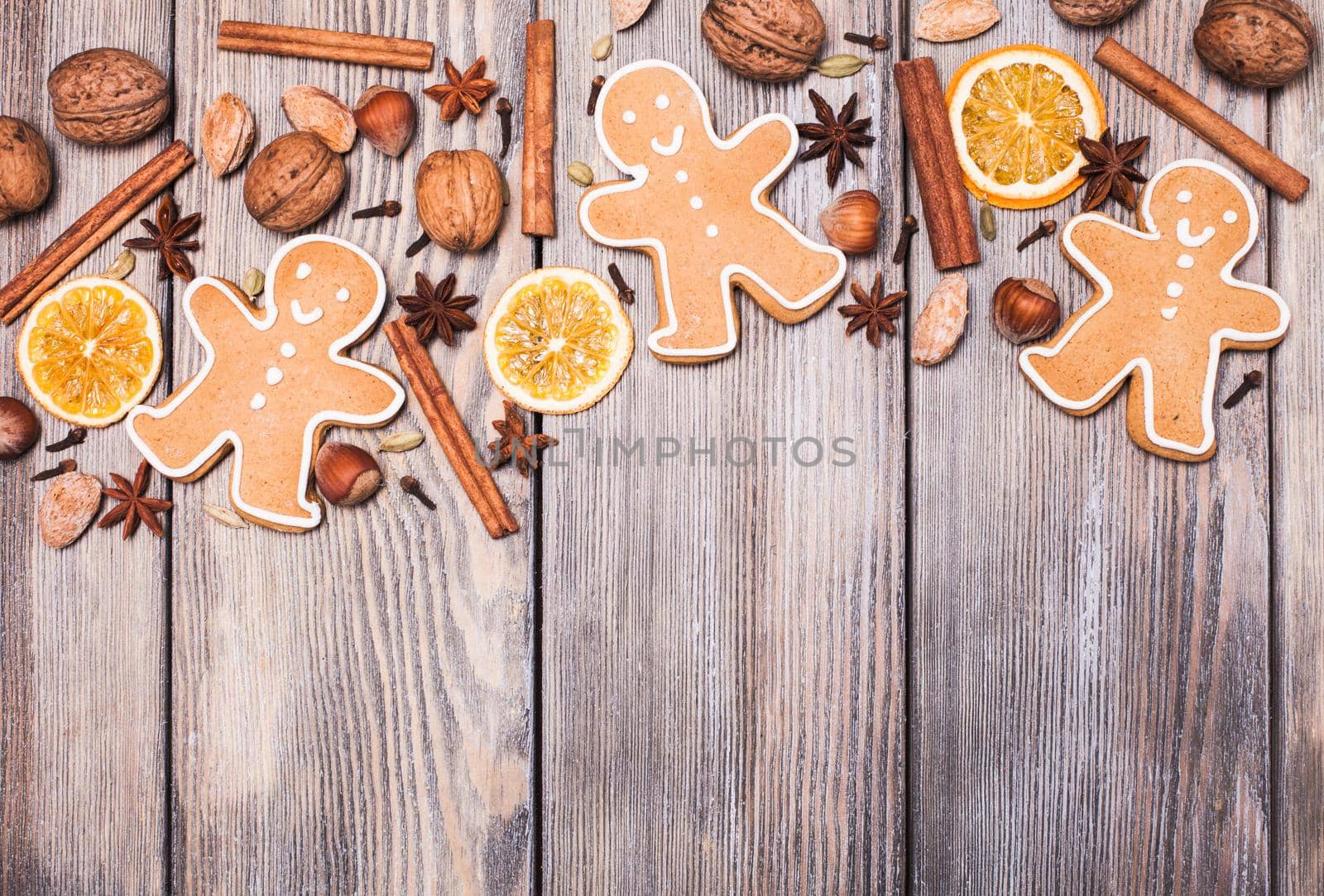 Gingerbreads with spices on the wooden table. Christmas aroma decor