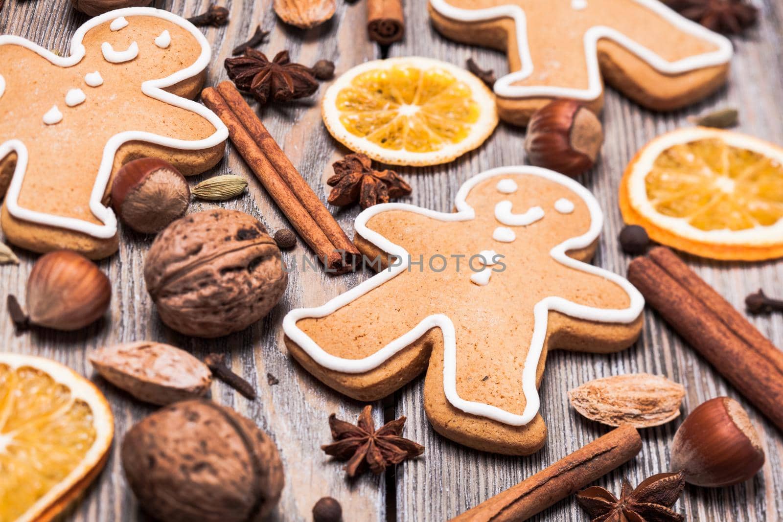 Gingerbreads with spices on the wooden table. Christmas aroma decor