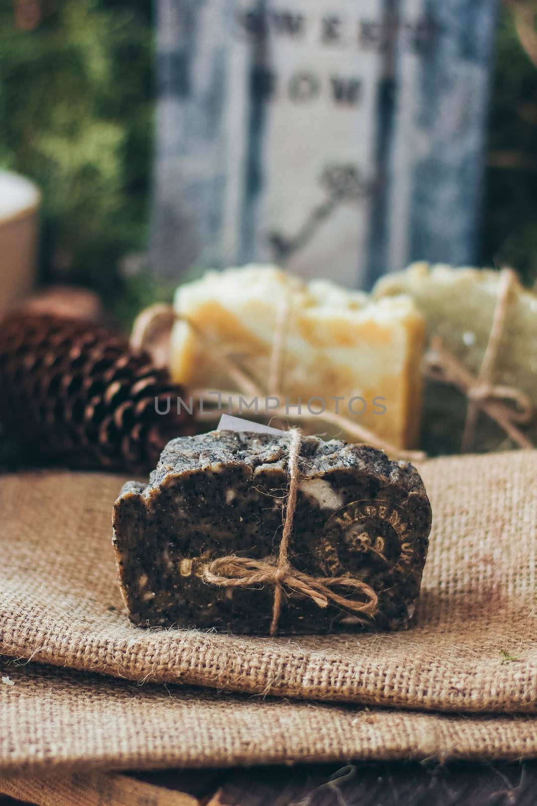 Pieces of beautiful natural handcrafted soap on wooden background with botanical elements, close up view. by mmp1206