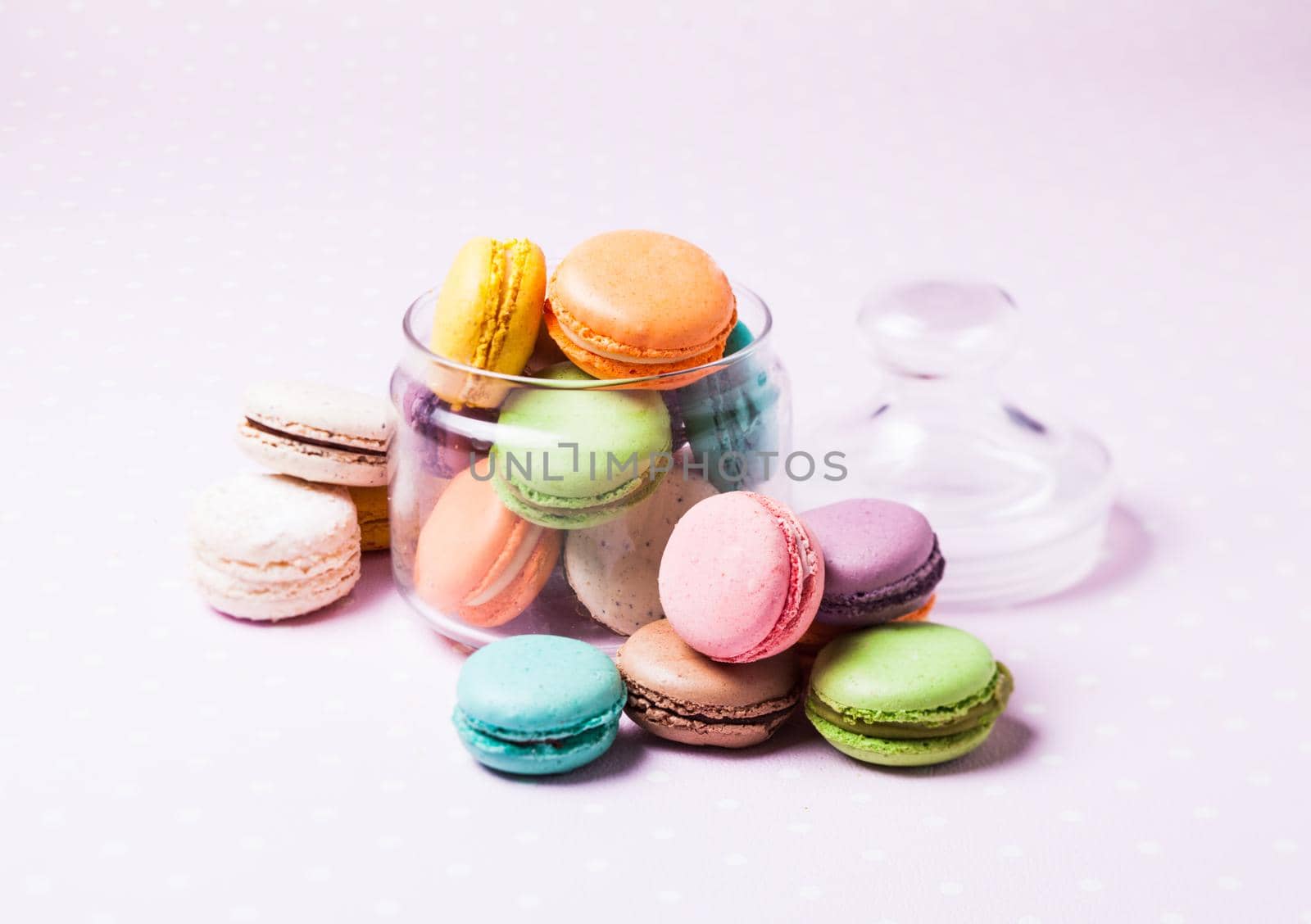 Colorful macaroons - french dessert in a glass jar